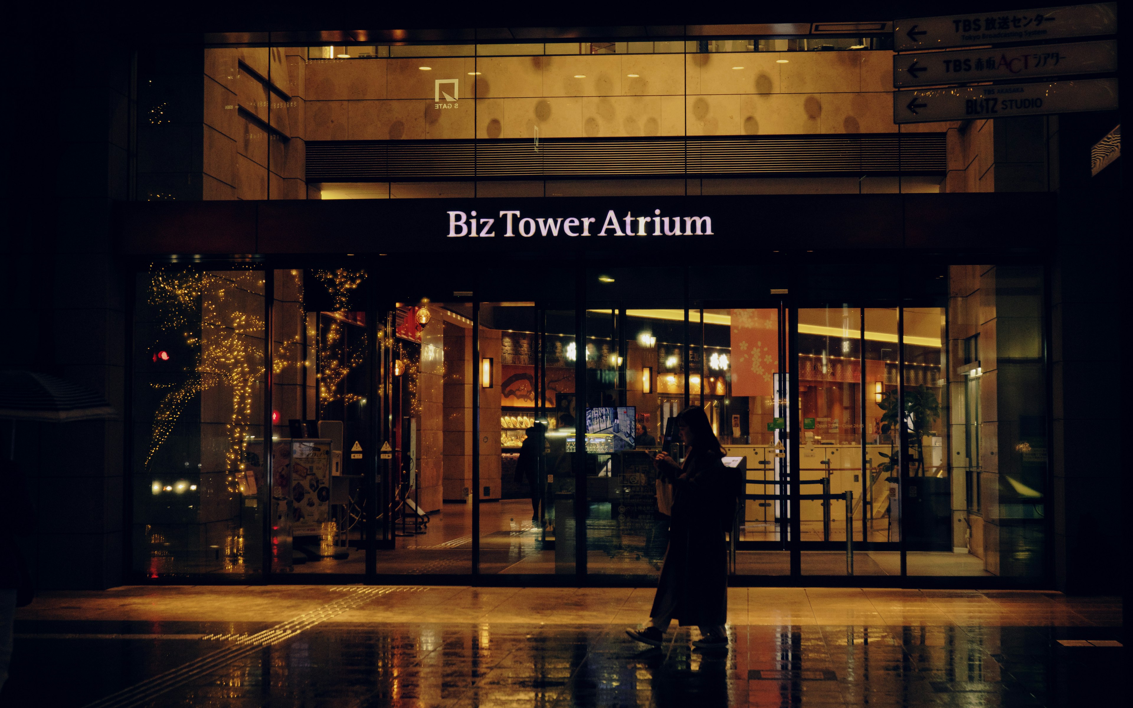 Night view of Biz Tower Atrium with reflections