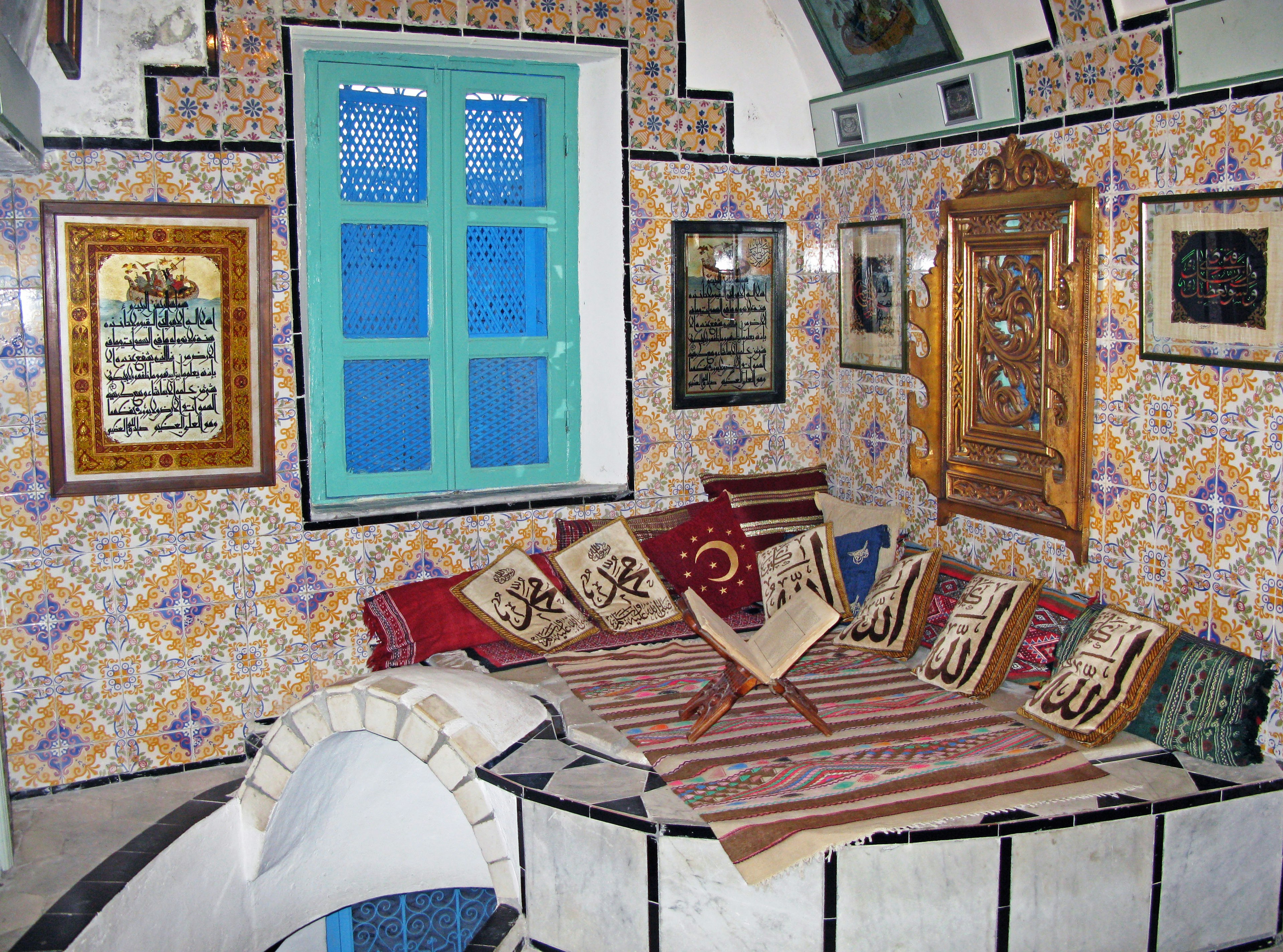 Interior of a room featuring a blue window and decorative wallpaper