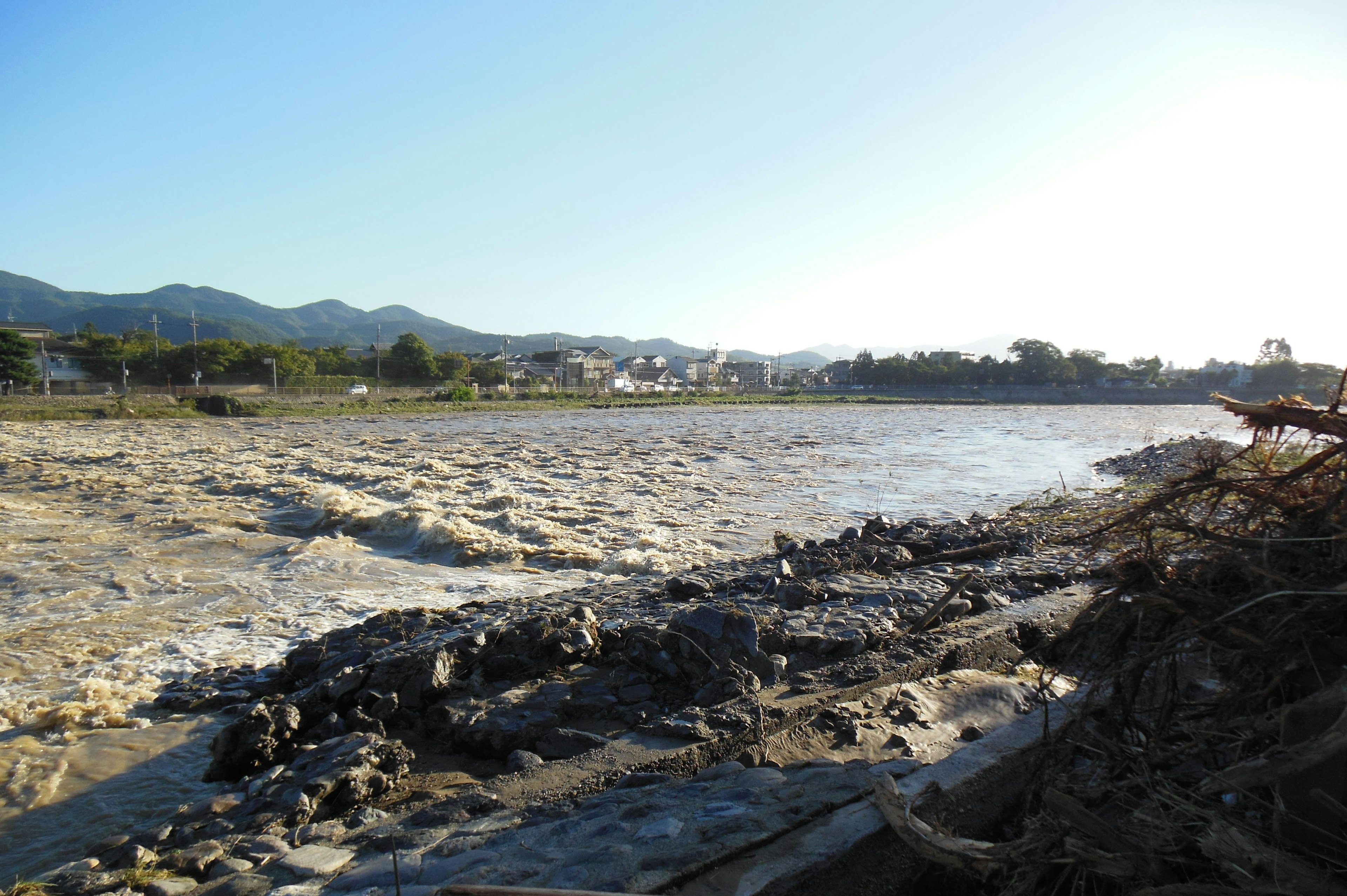 Landscape featuring a river's flow and mountain backdrop