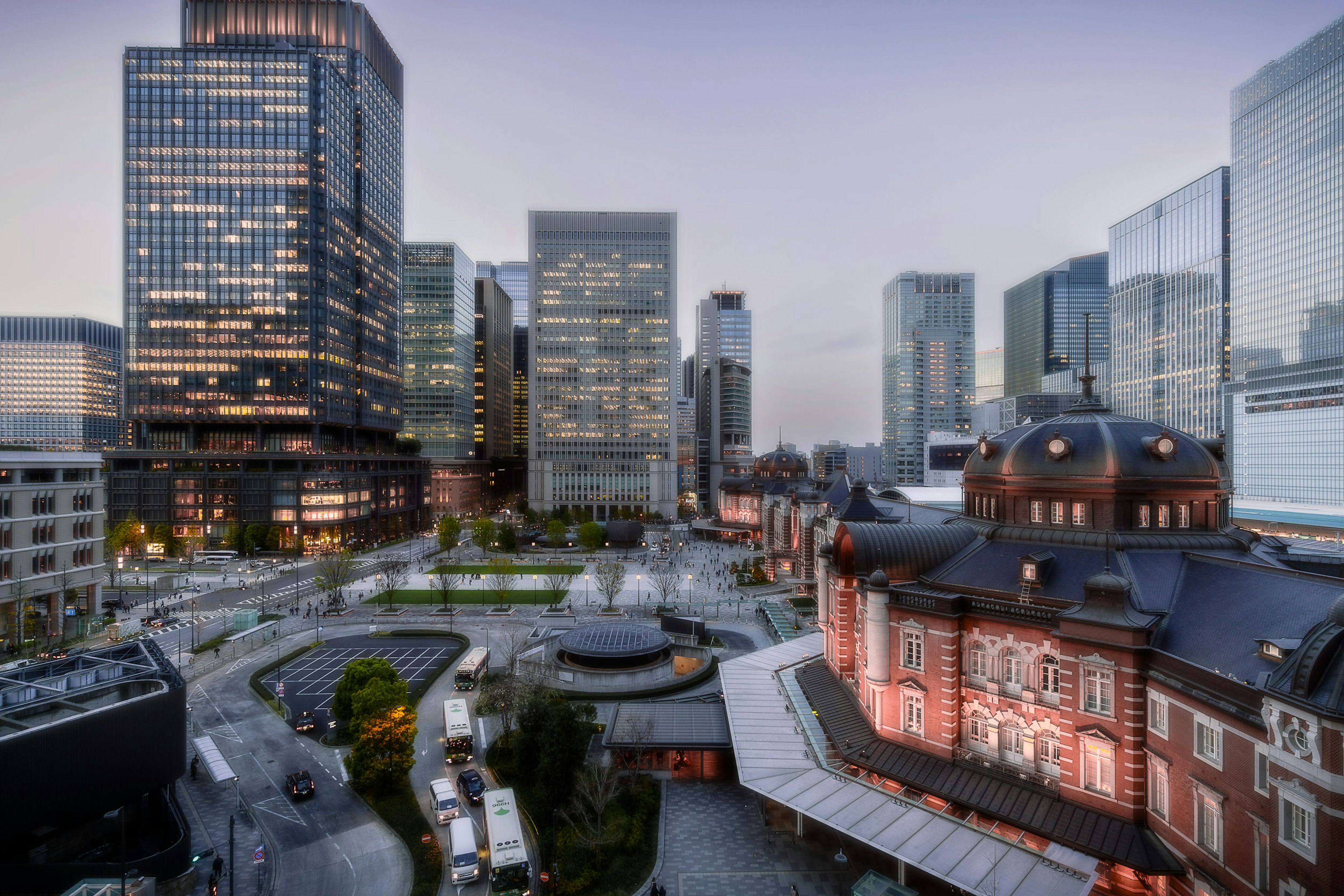 Tokyo Station with modern skyscrapers at dusk