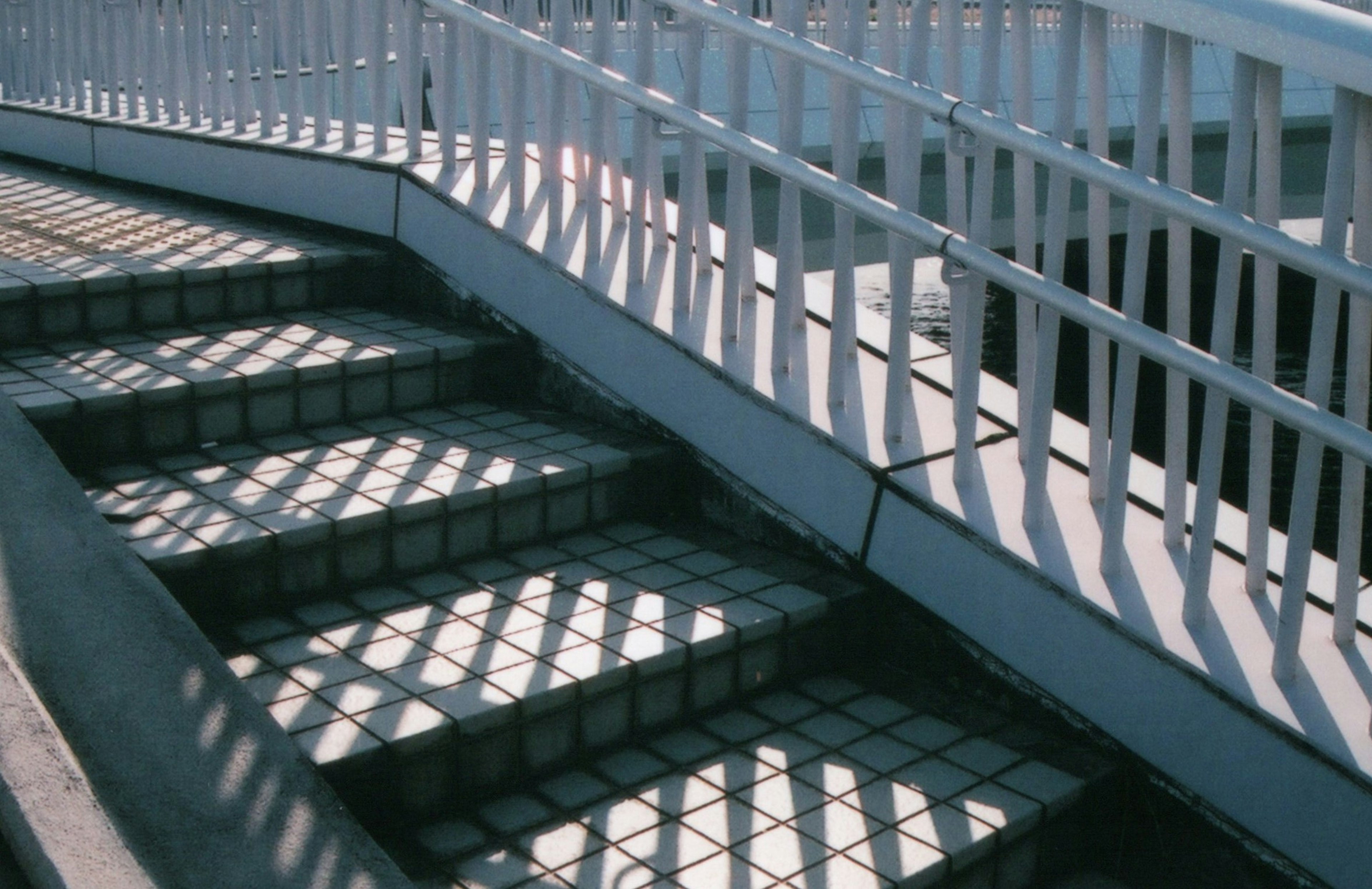 Image of stairs with a curved railing casting interesting shadows