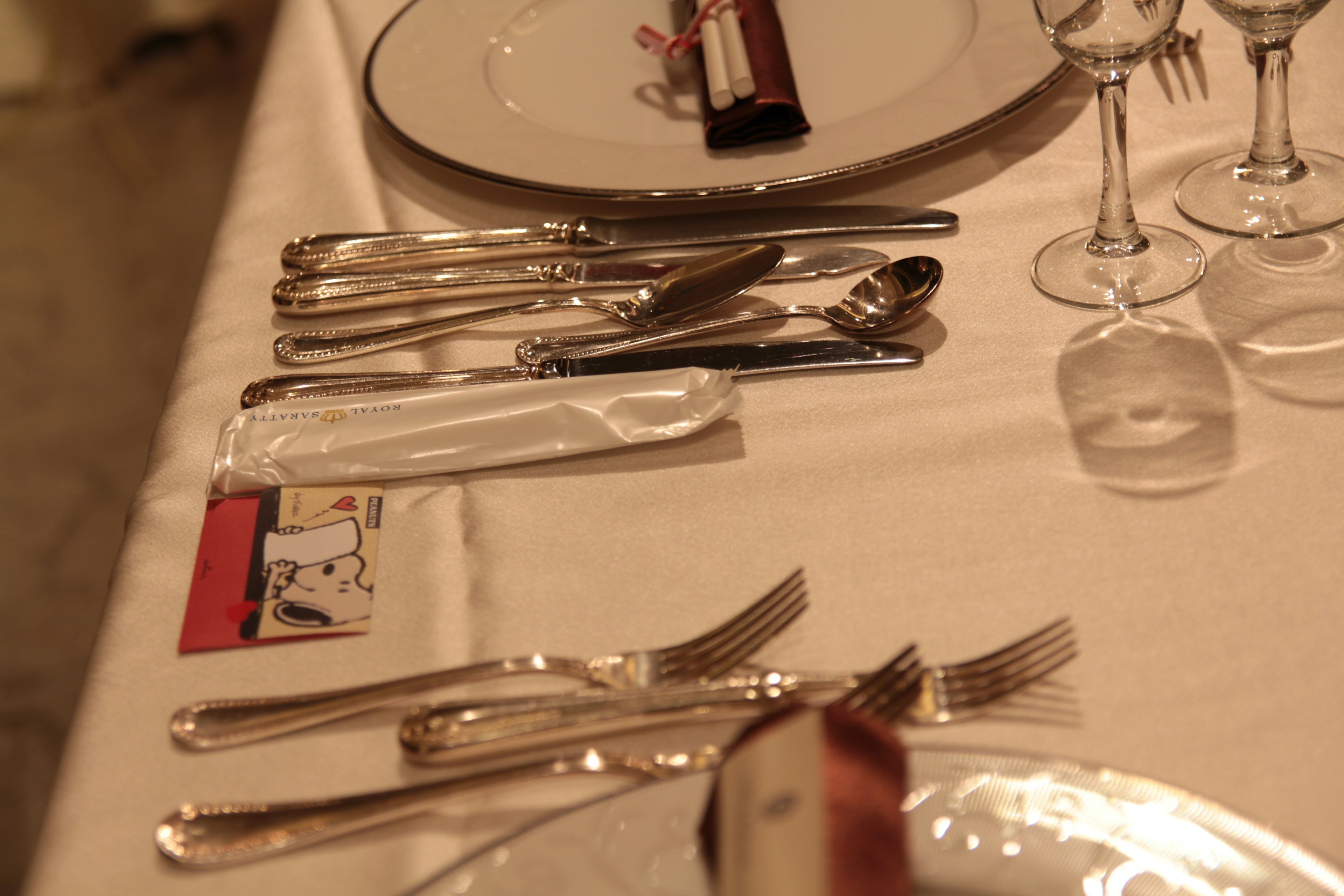 Table setting featuring arranged cutlery and glassware