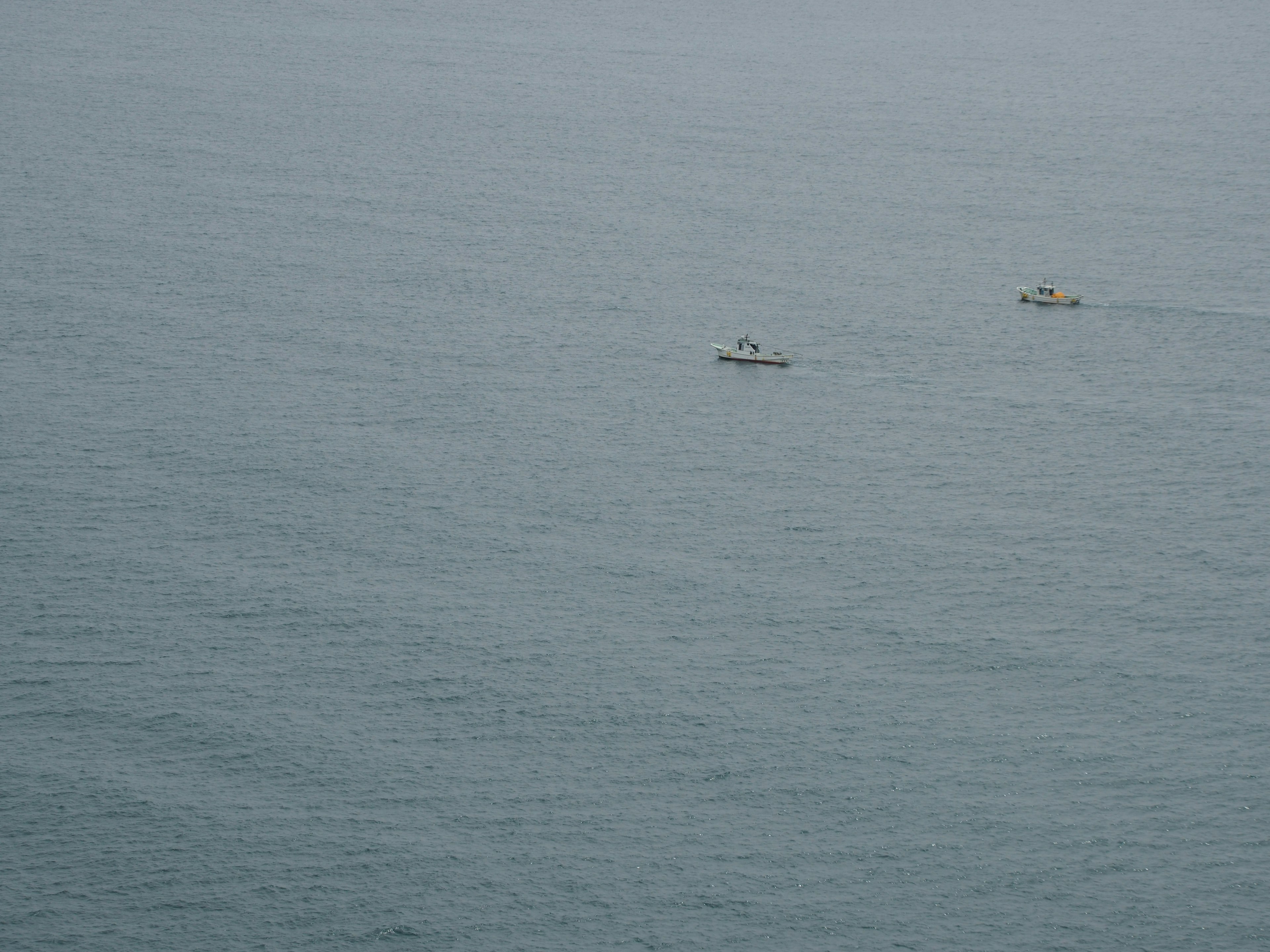 Two small boats floating on the sea