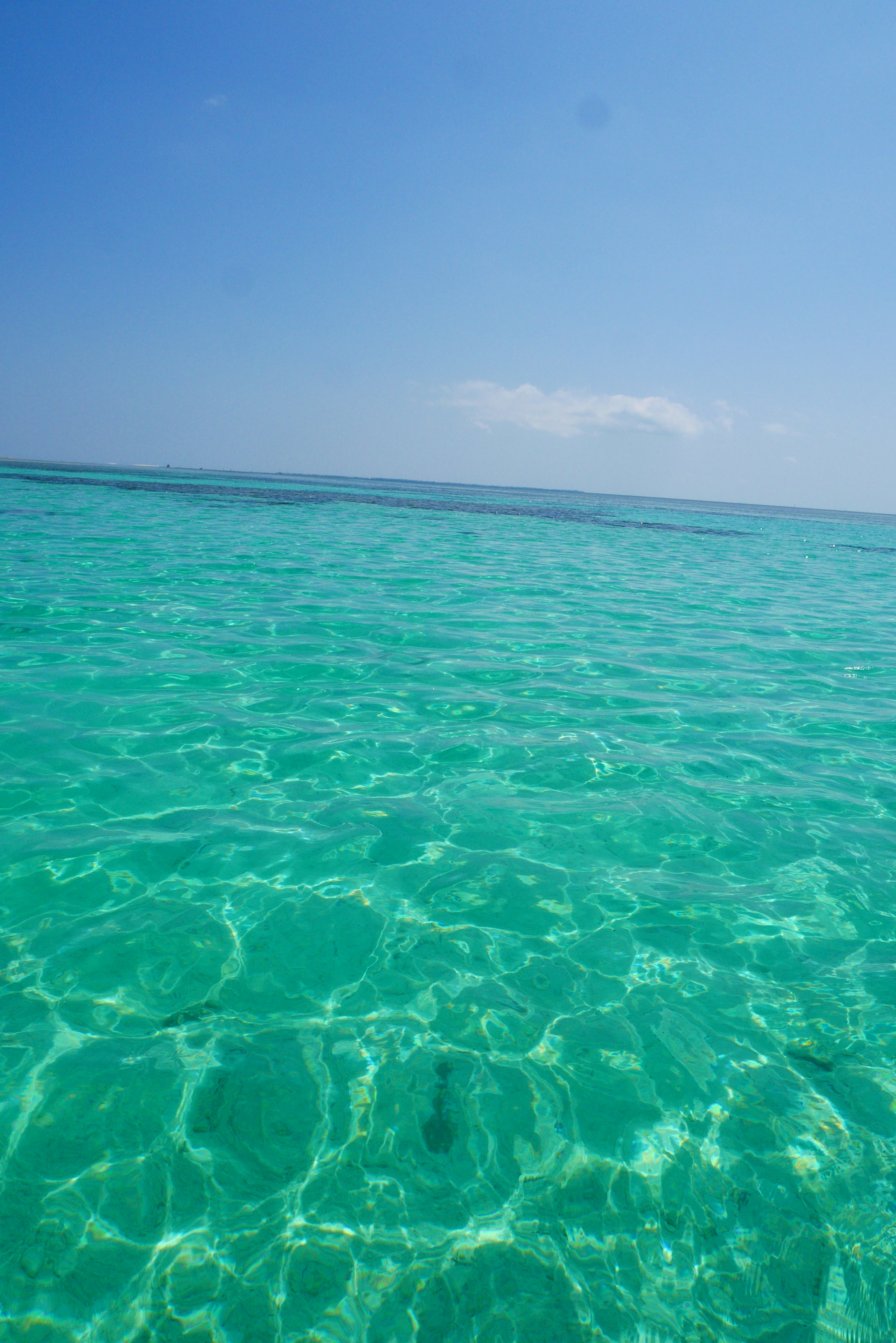 Clear turquoise water under a bright blue sky