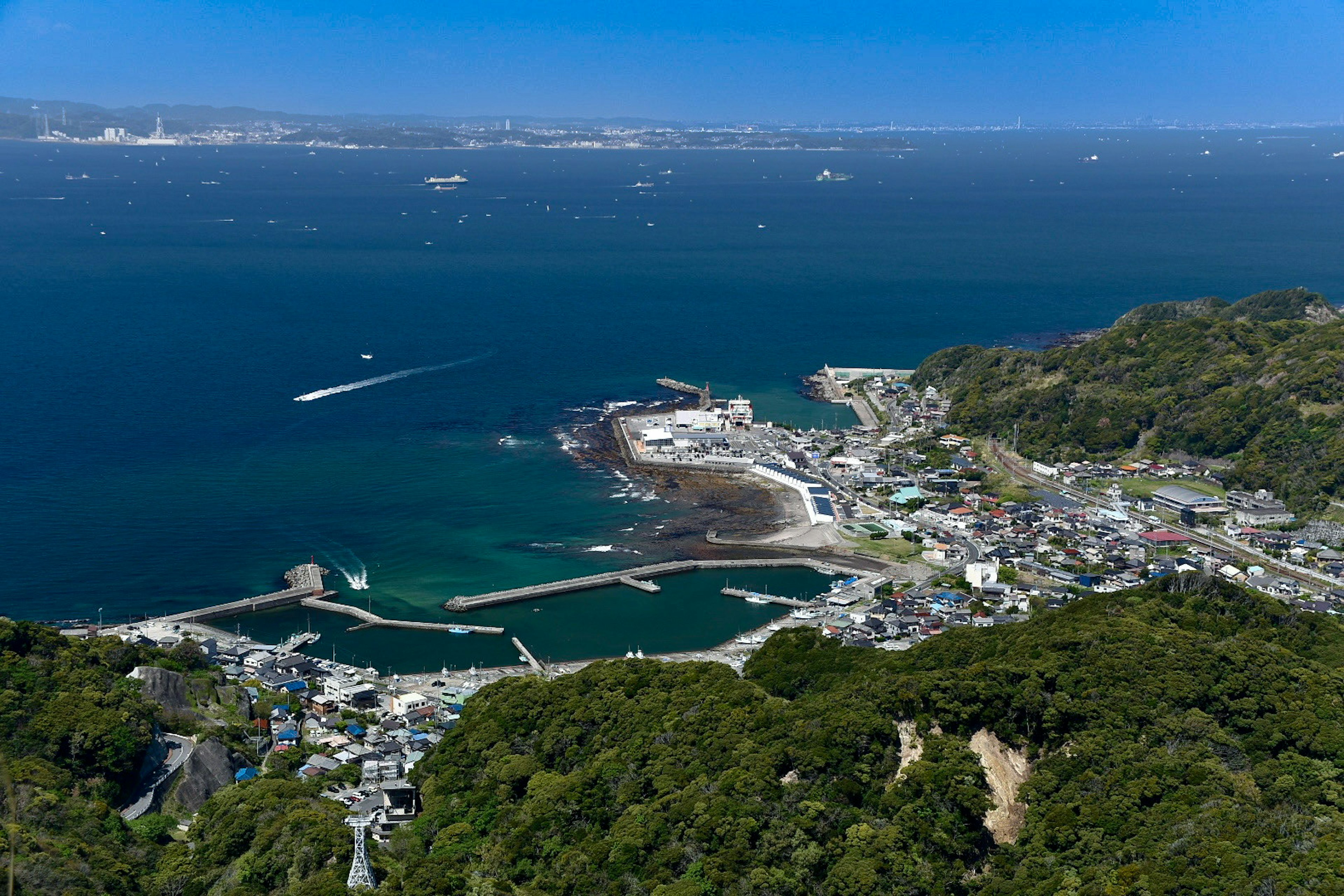 A scenic view of a coastal town with a harbor and boats