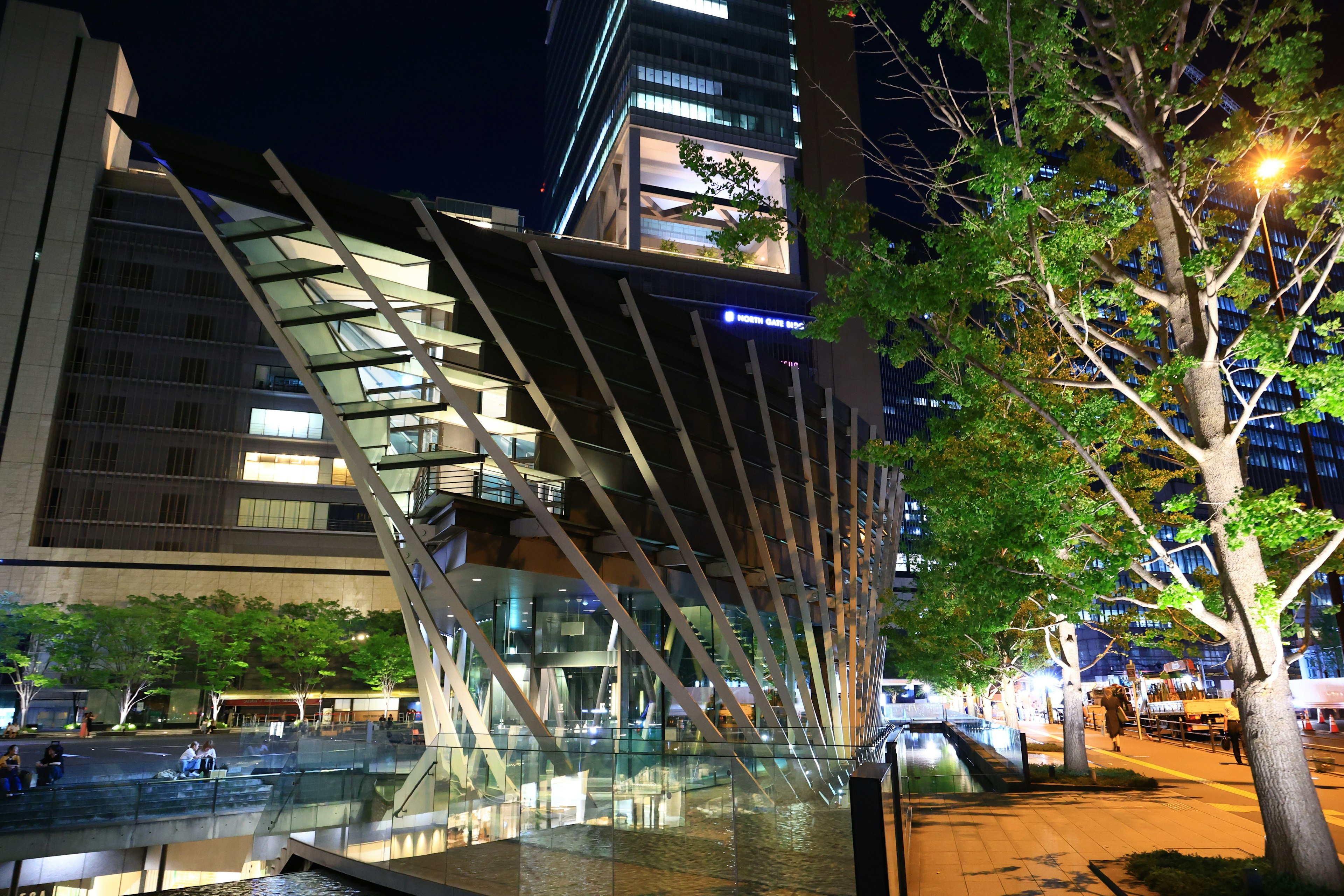 Modern building with glass staircase in urban night scene