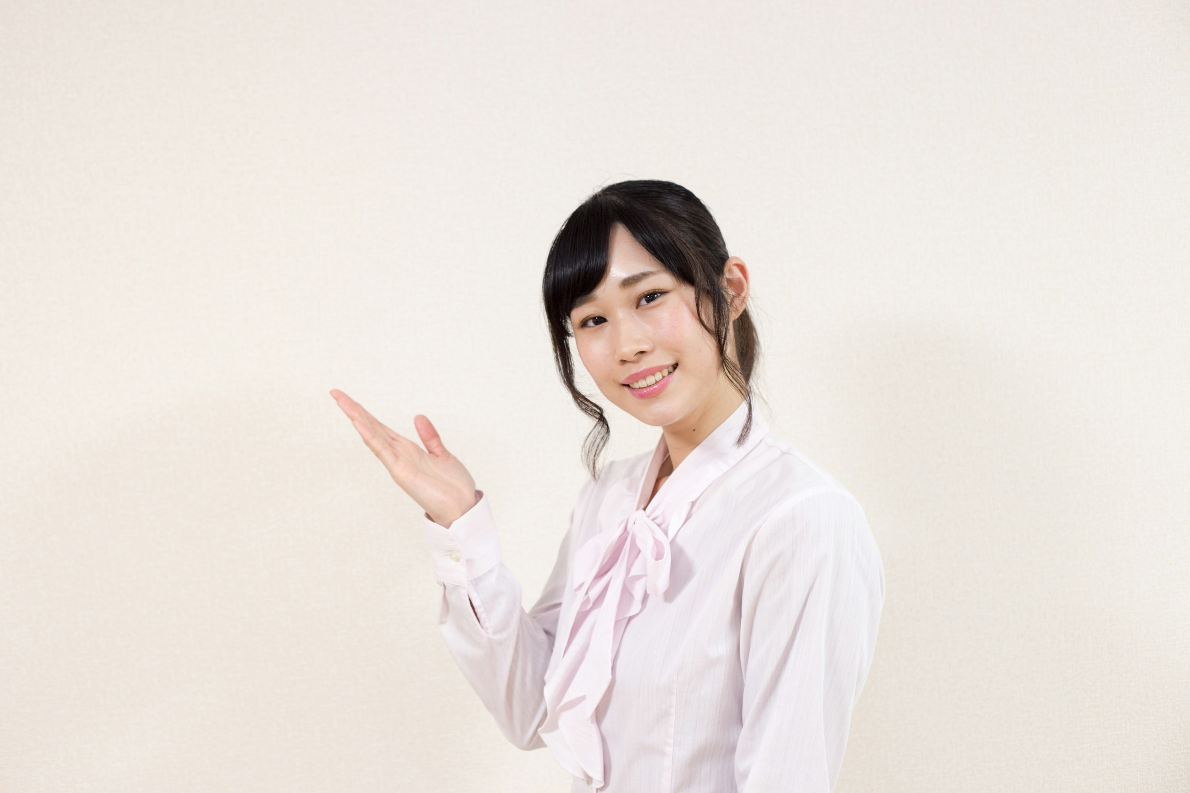 Woman gesturing with hand in front of white background