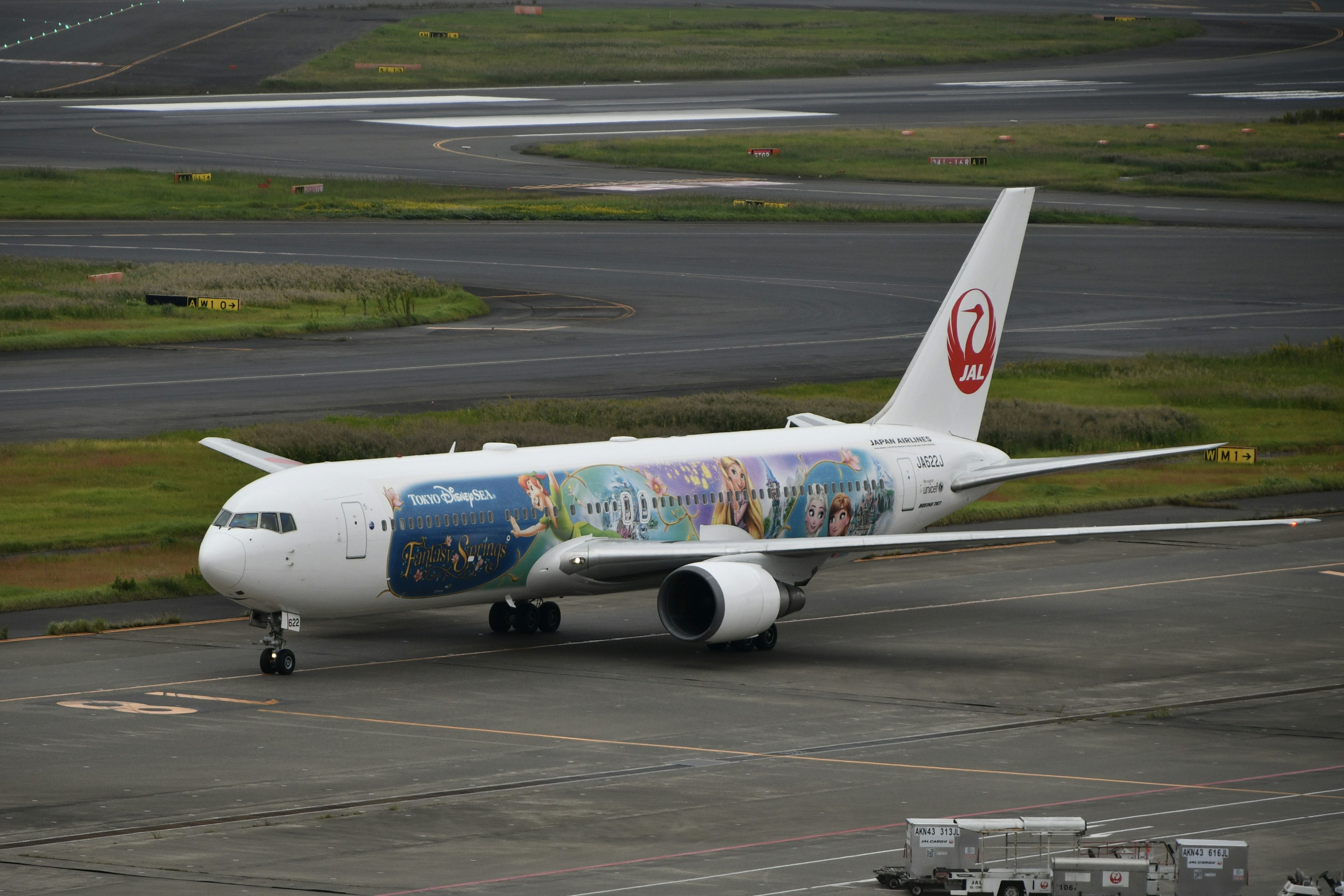 Japan Airlines Boeing 777 with special artwork taxiing on the airport runway