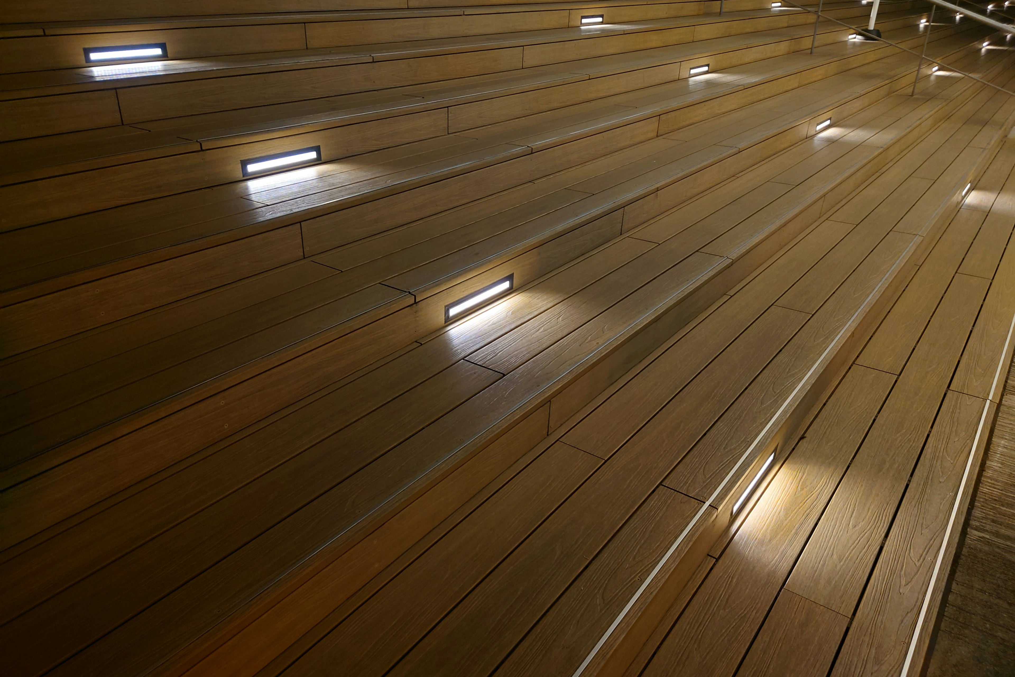 Diagonal view of wooden stairs with embedded lighting