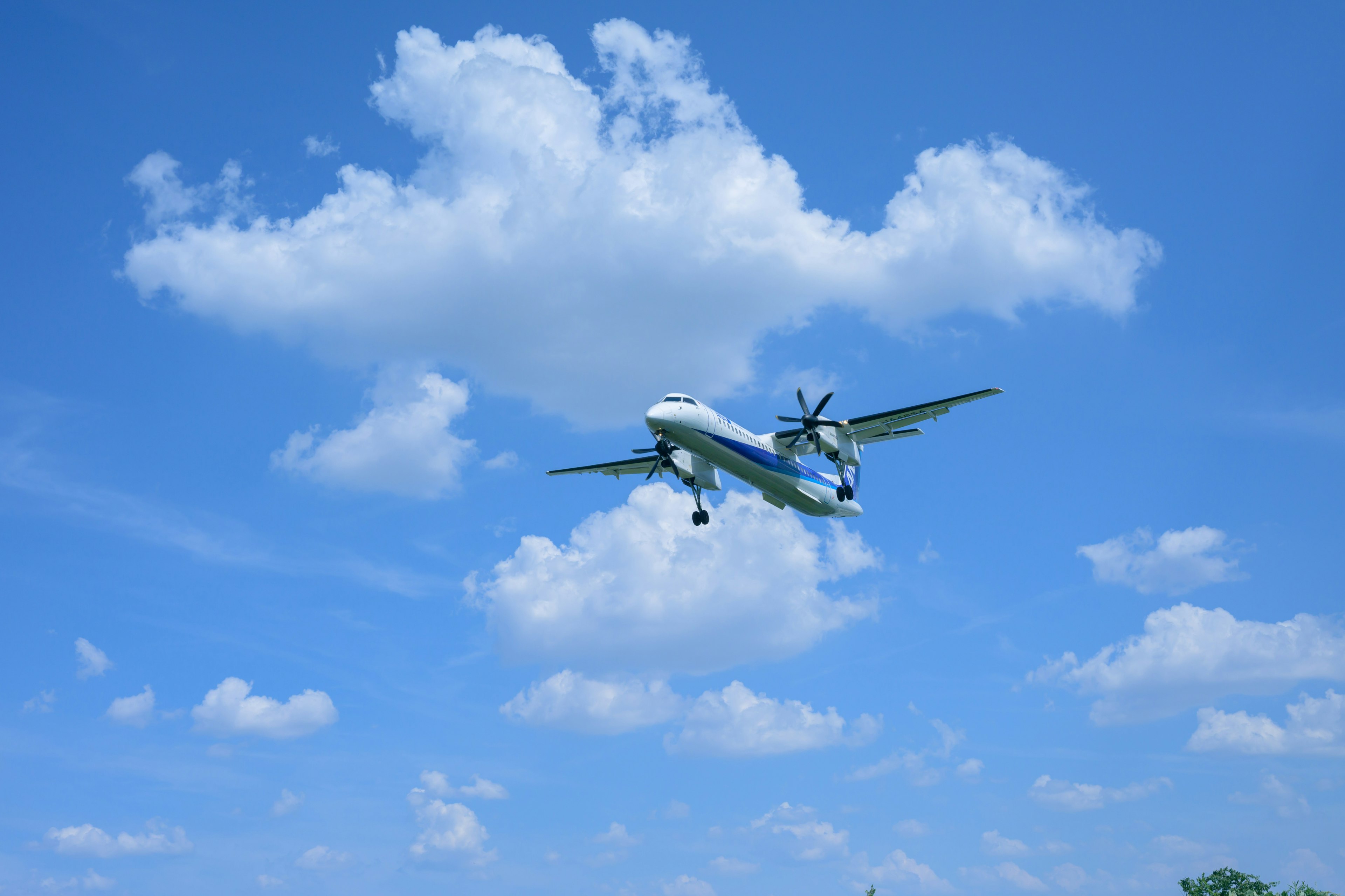 Propeller airplane flying against a blue sky