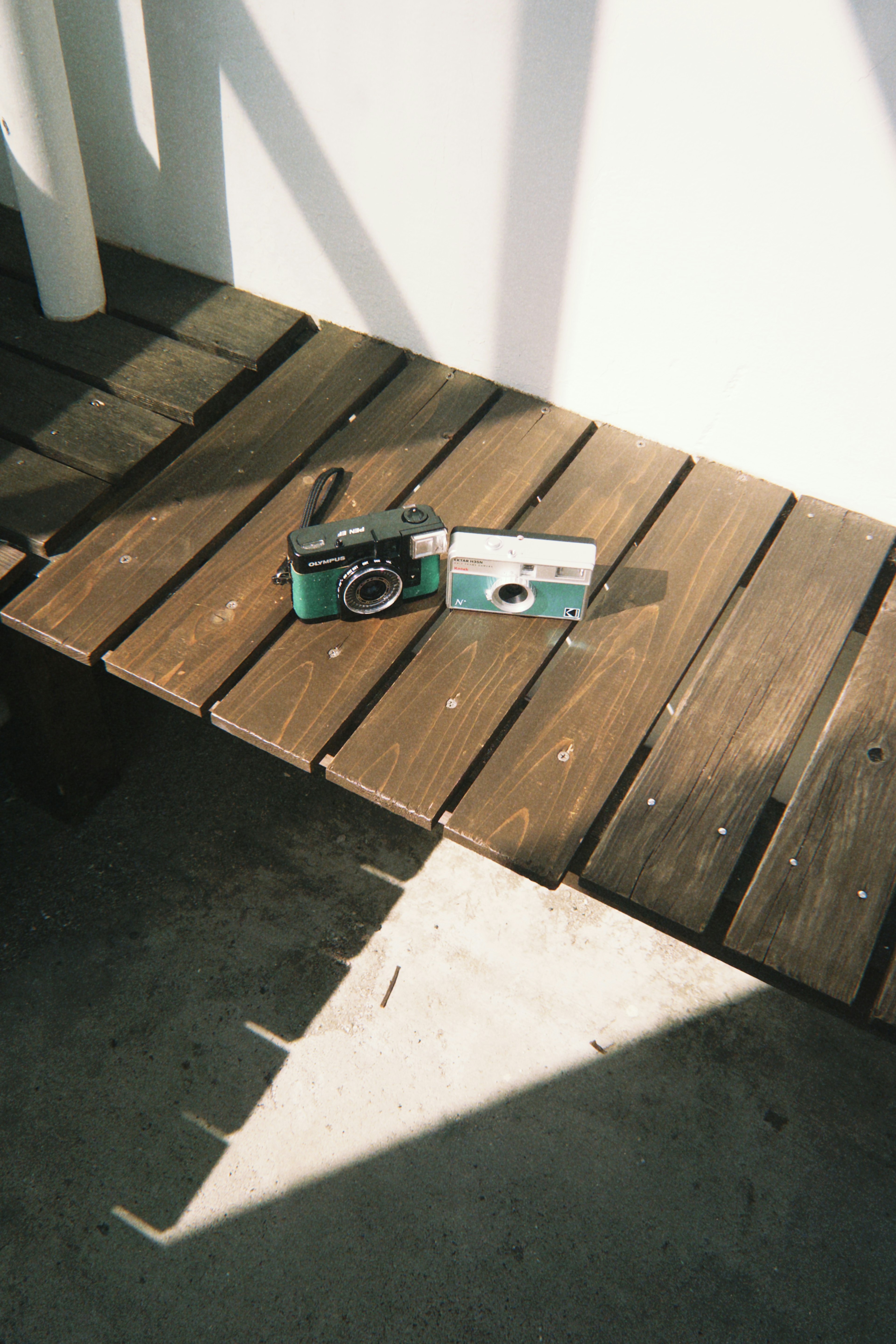 Camera and film package on a wooden bench