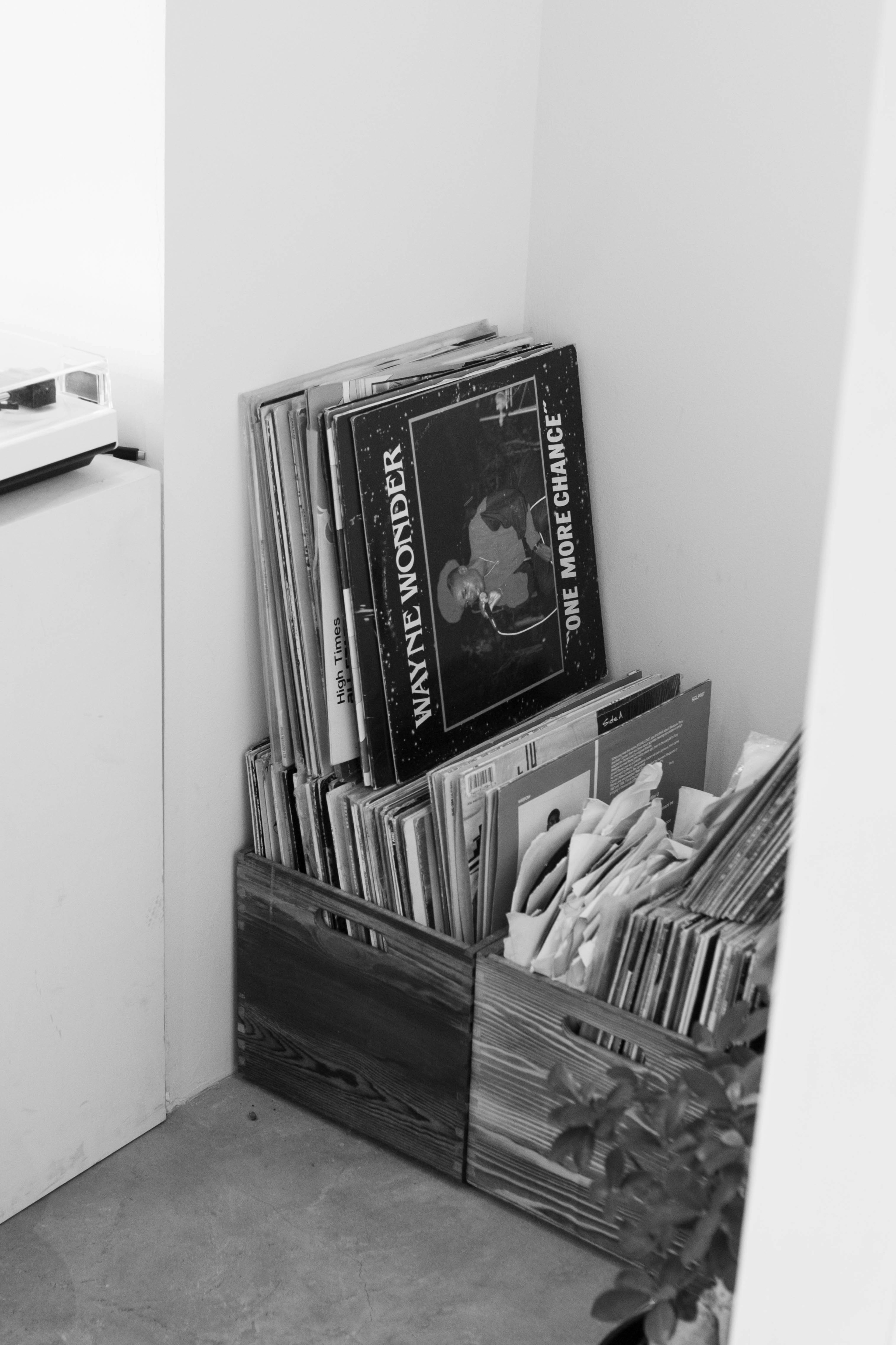 Corner with wooden crates holding black and white records