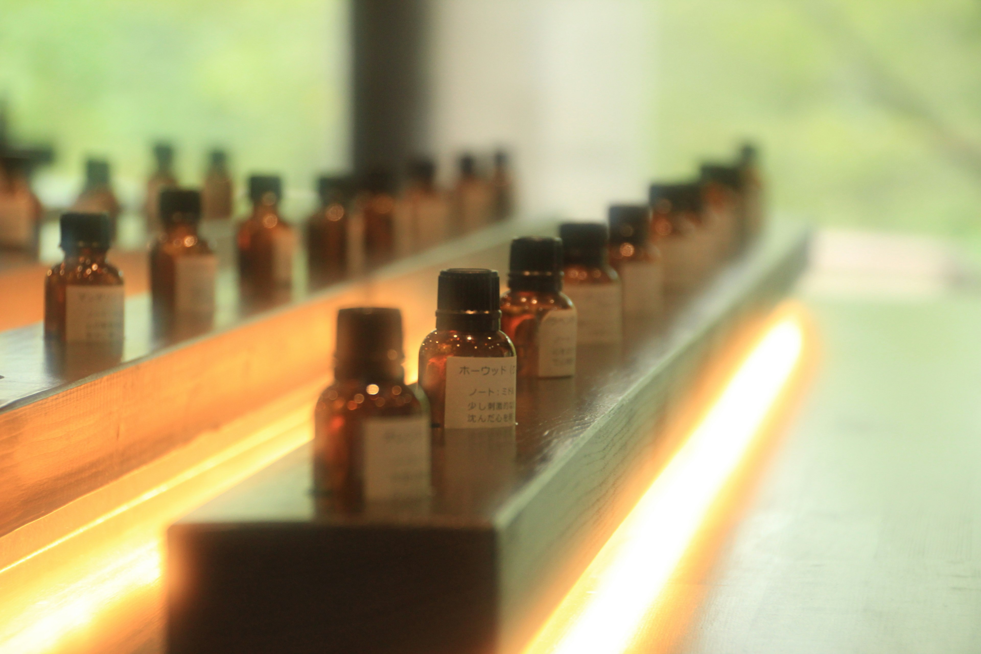 Set of brown glass bottles arranged on a shelf with soft lighting