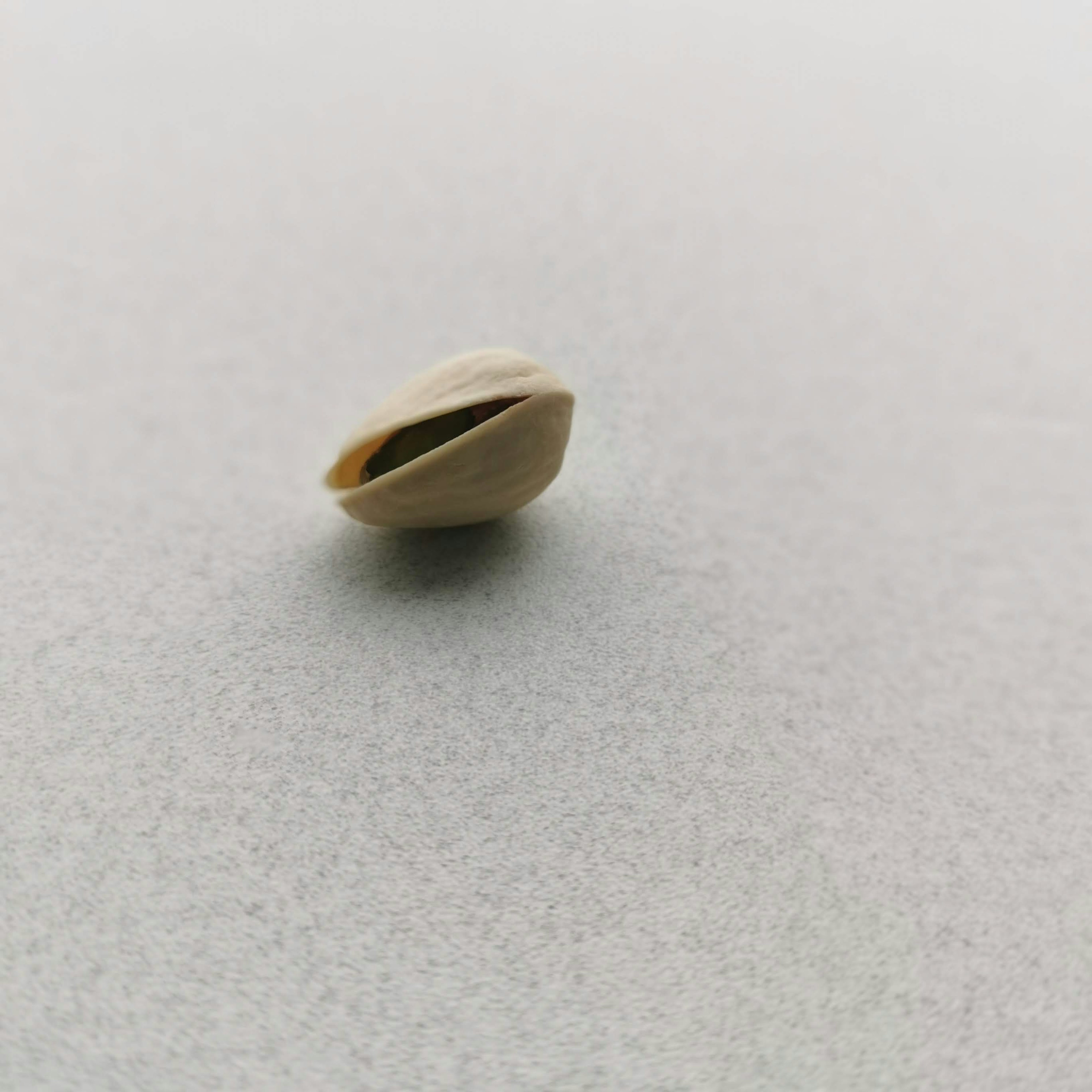 A single pistachio shell resting on a table