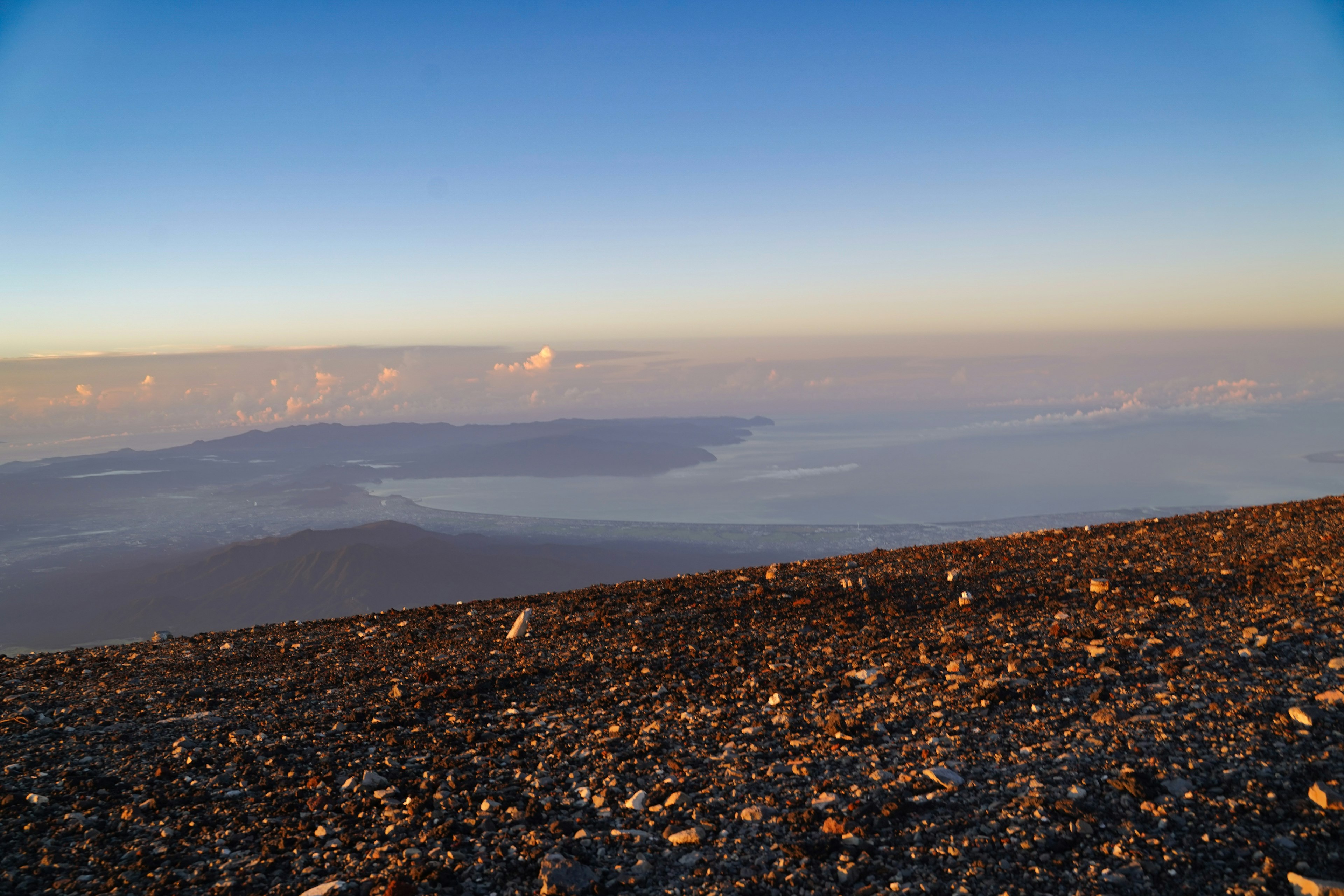 Beautiful view from the mountain summit featuring a blue sky and distant islands