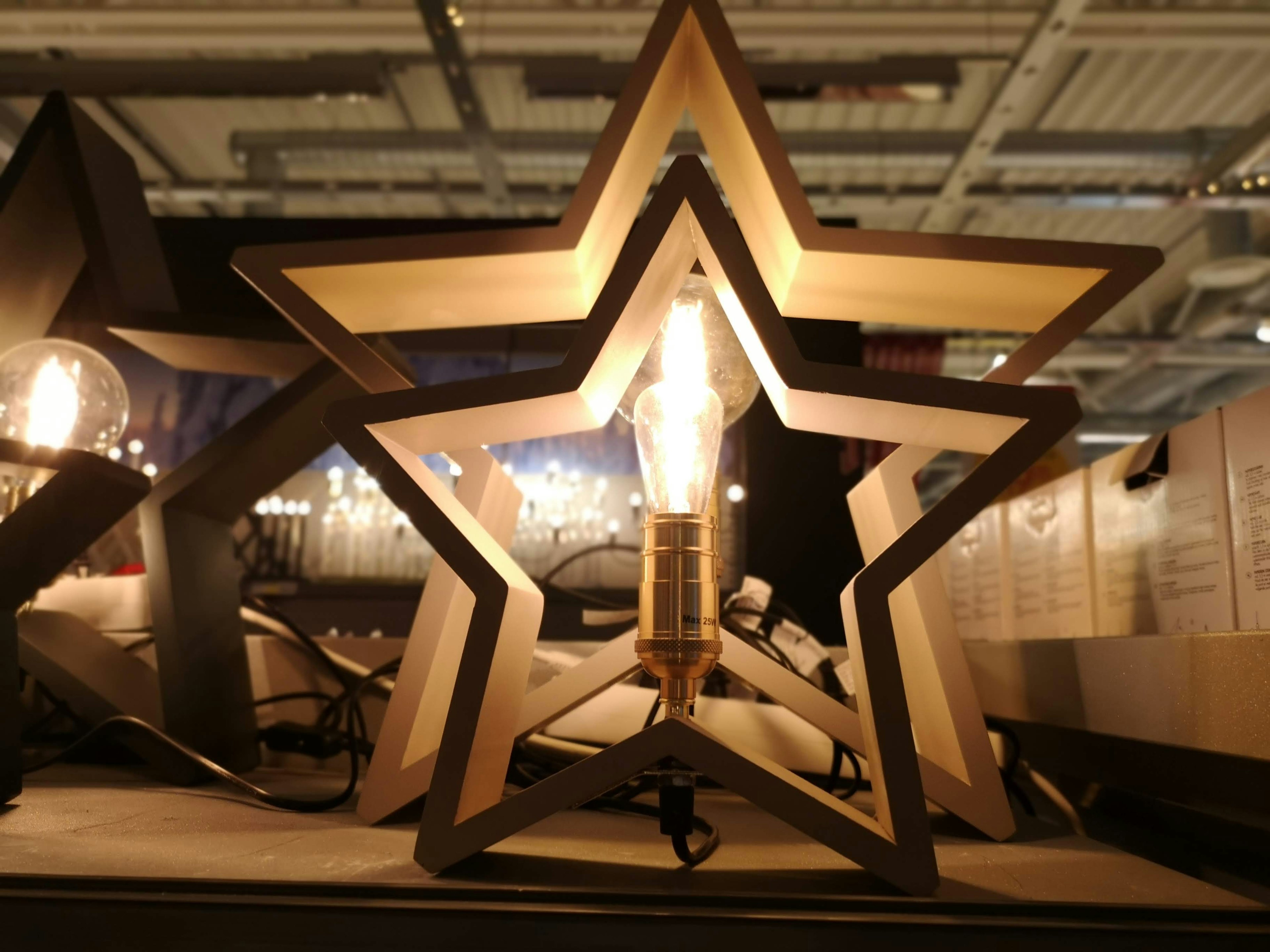 Wooden star-shaped lamp illuminated in the image