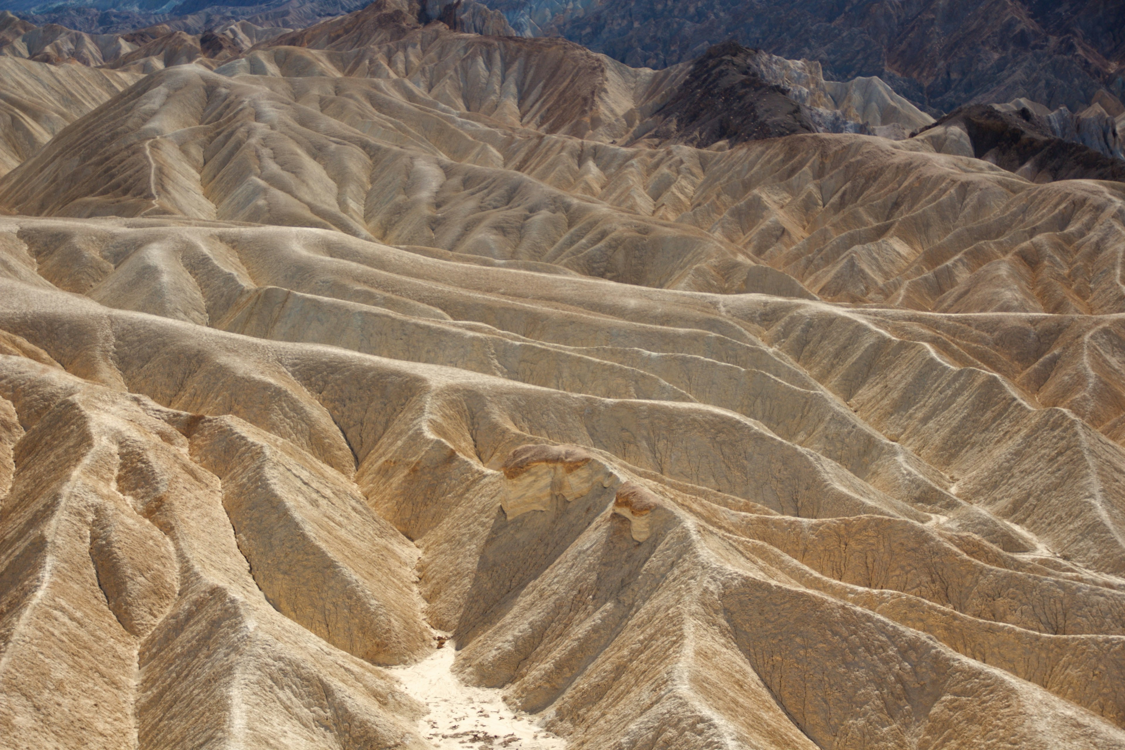 Aerial view of dry mountainous terrain with distinct ridges and valleys