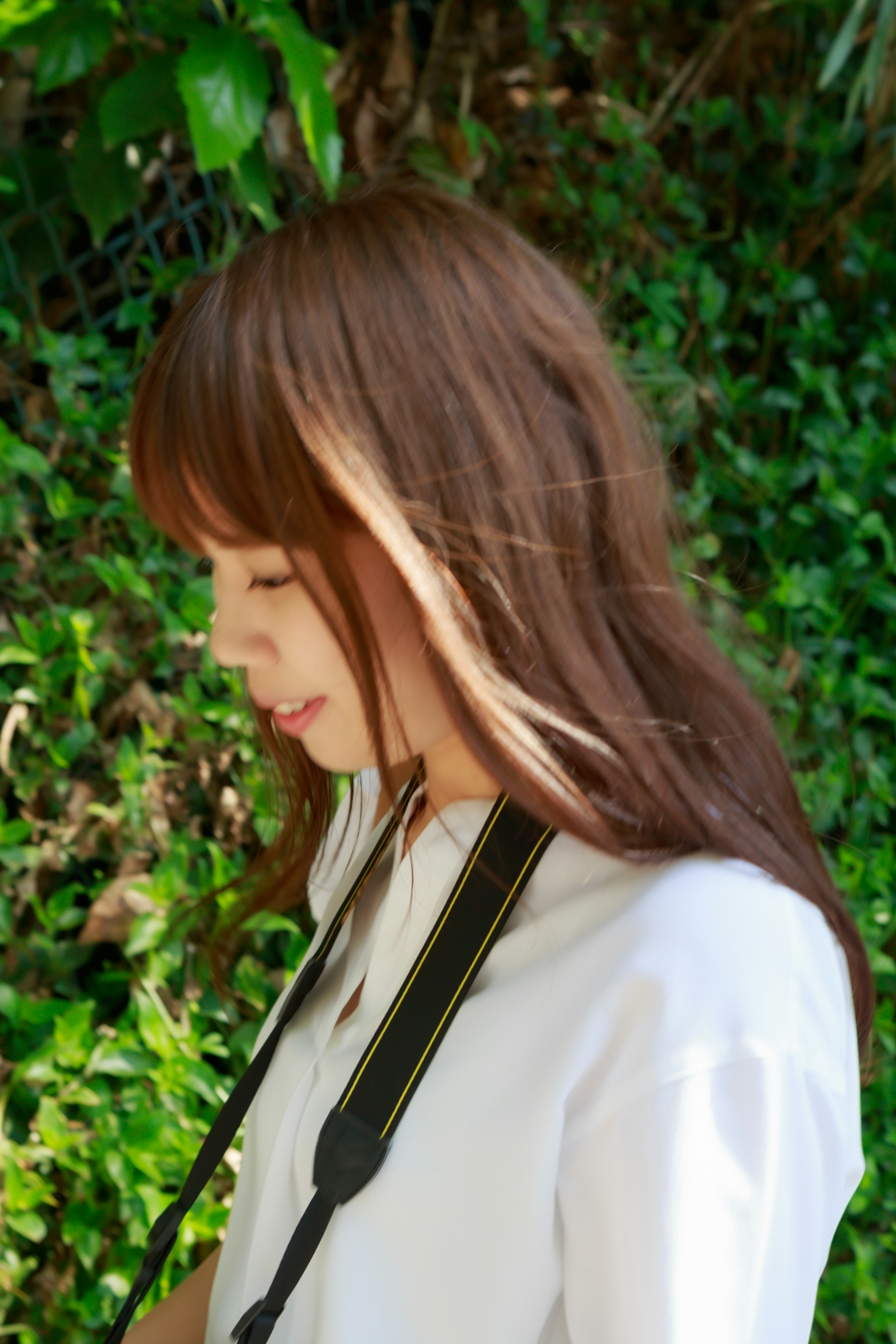 Profile of a woman smiling against a green background