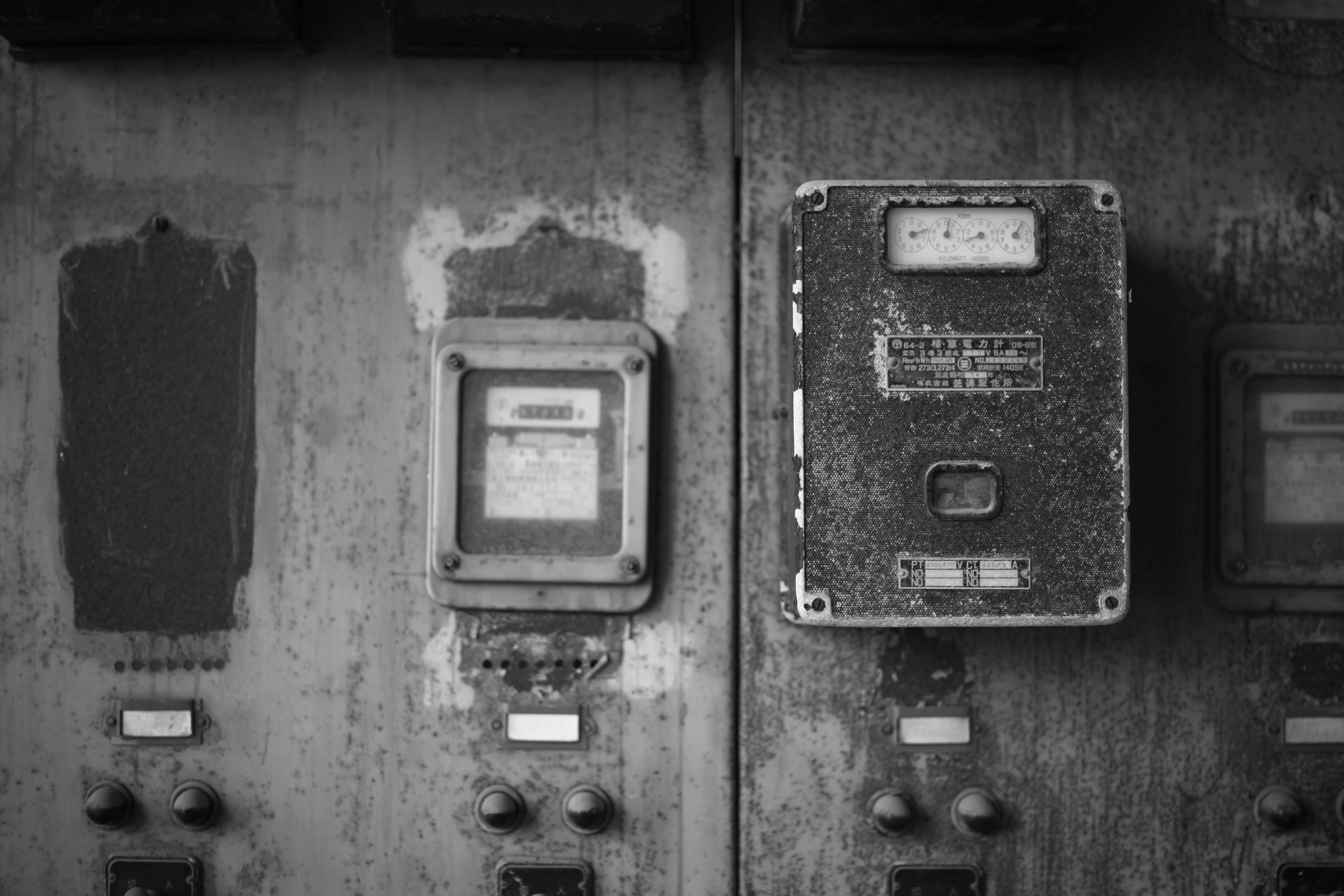 Image of old electric meters mounted on a dirty wall