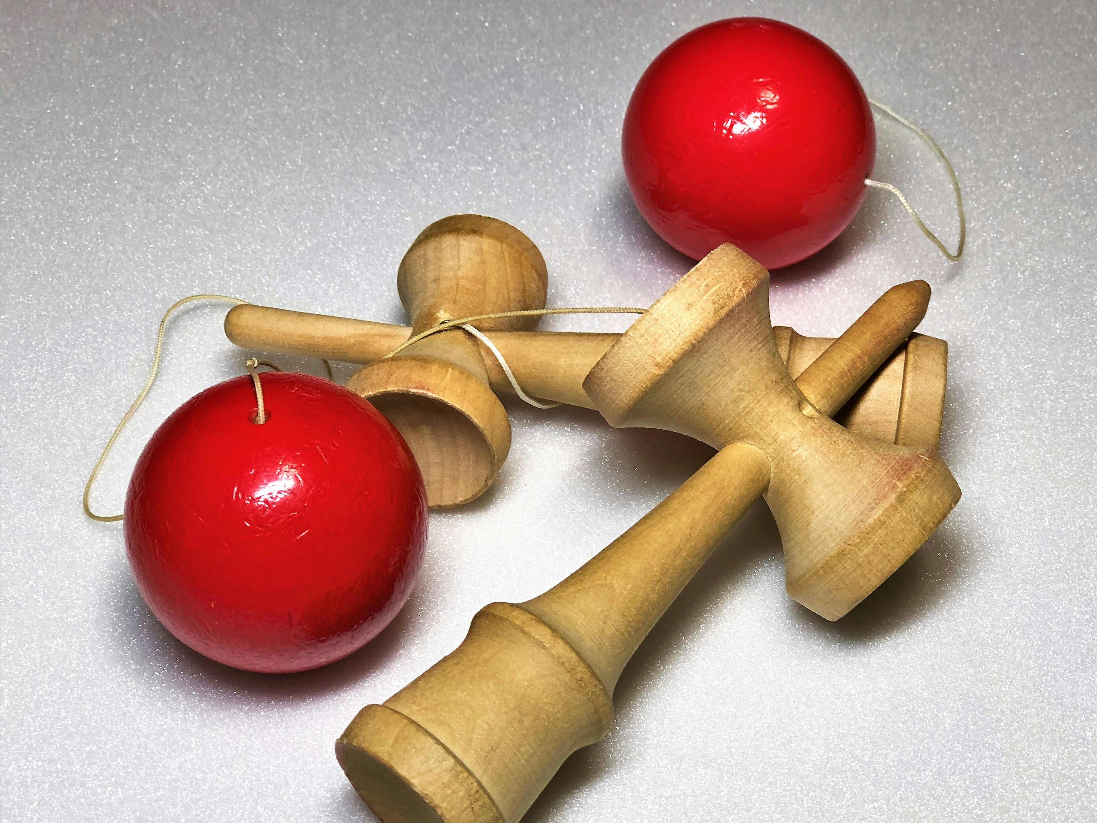 Red balls and wooden kendama components tangled together