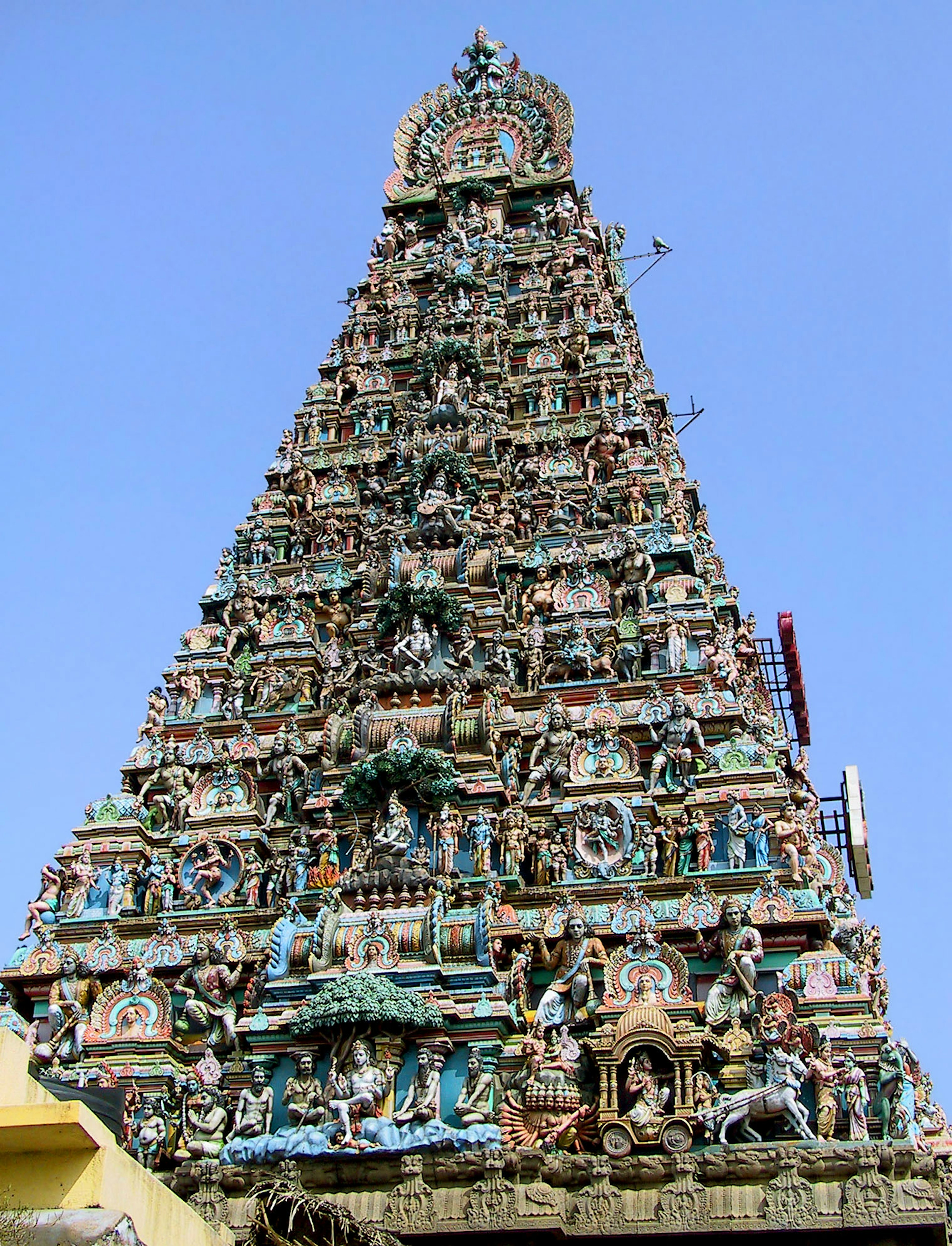 Torre alta de un templo adornada con esculturas coloridas