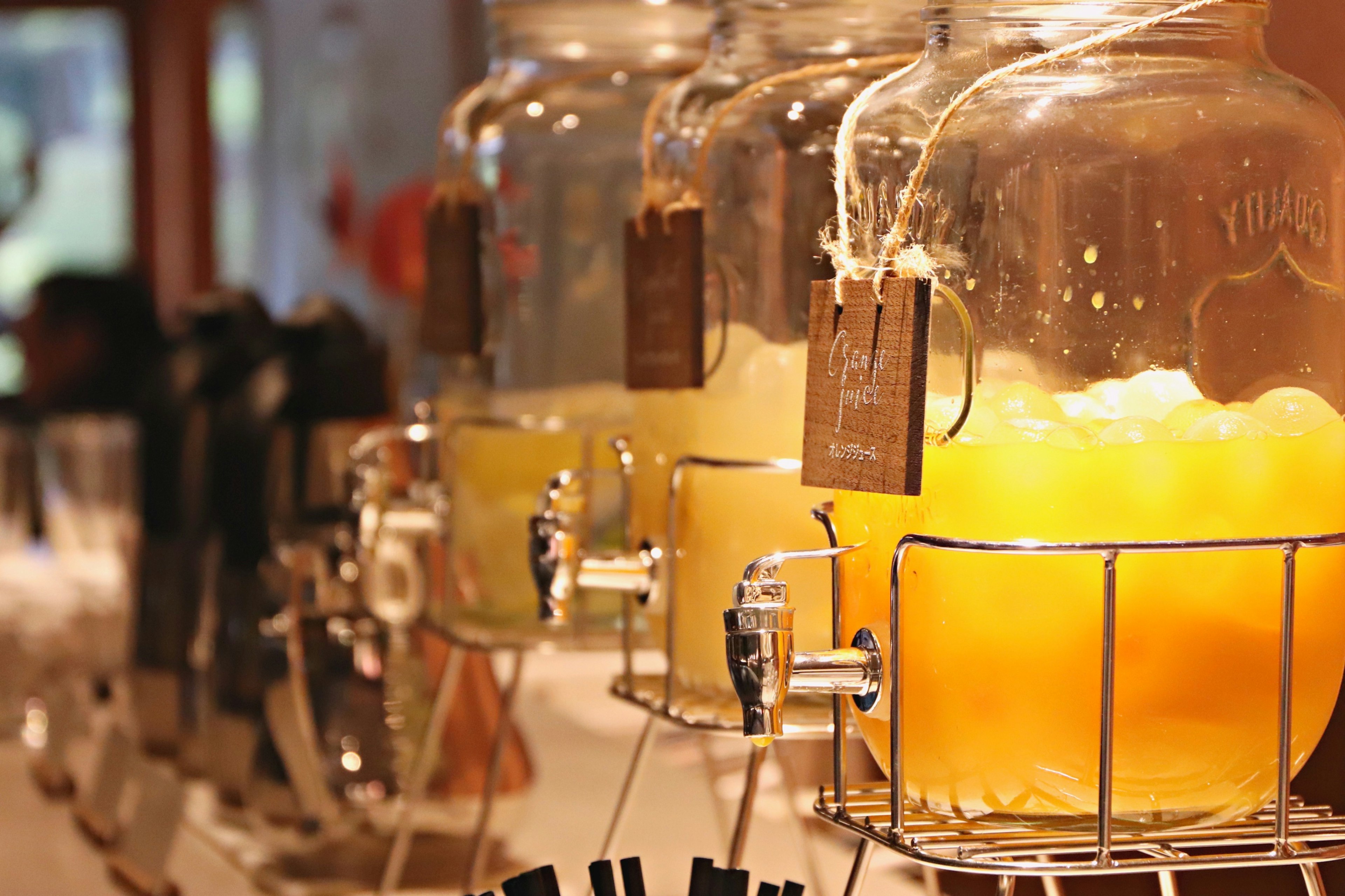 Photo of beverage dispensers lined up on a table