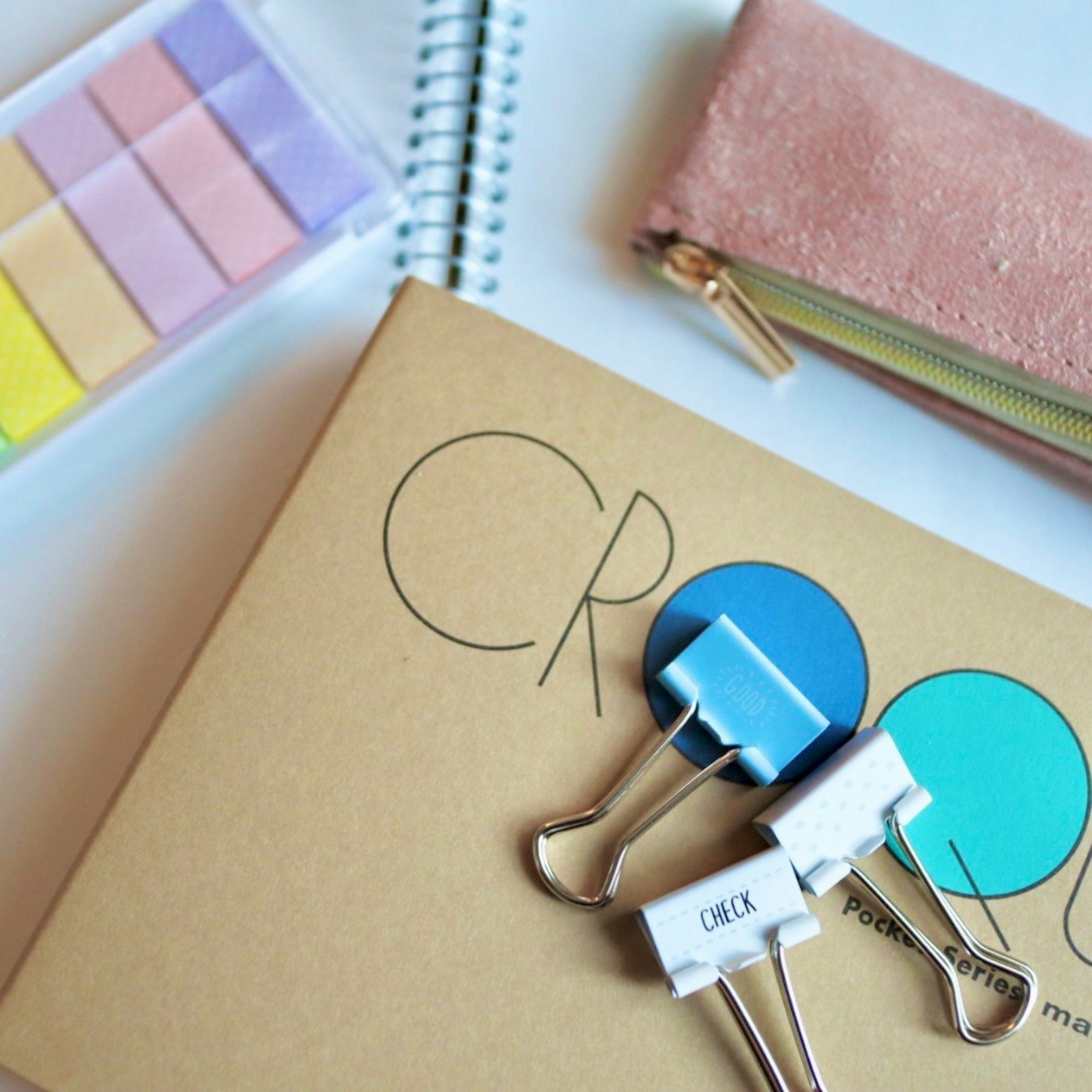 Colorful stationery and notebook arranged on a desktop