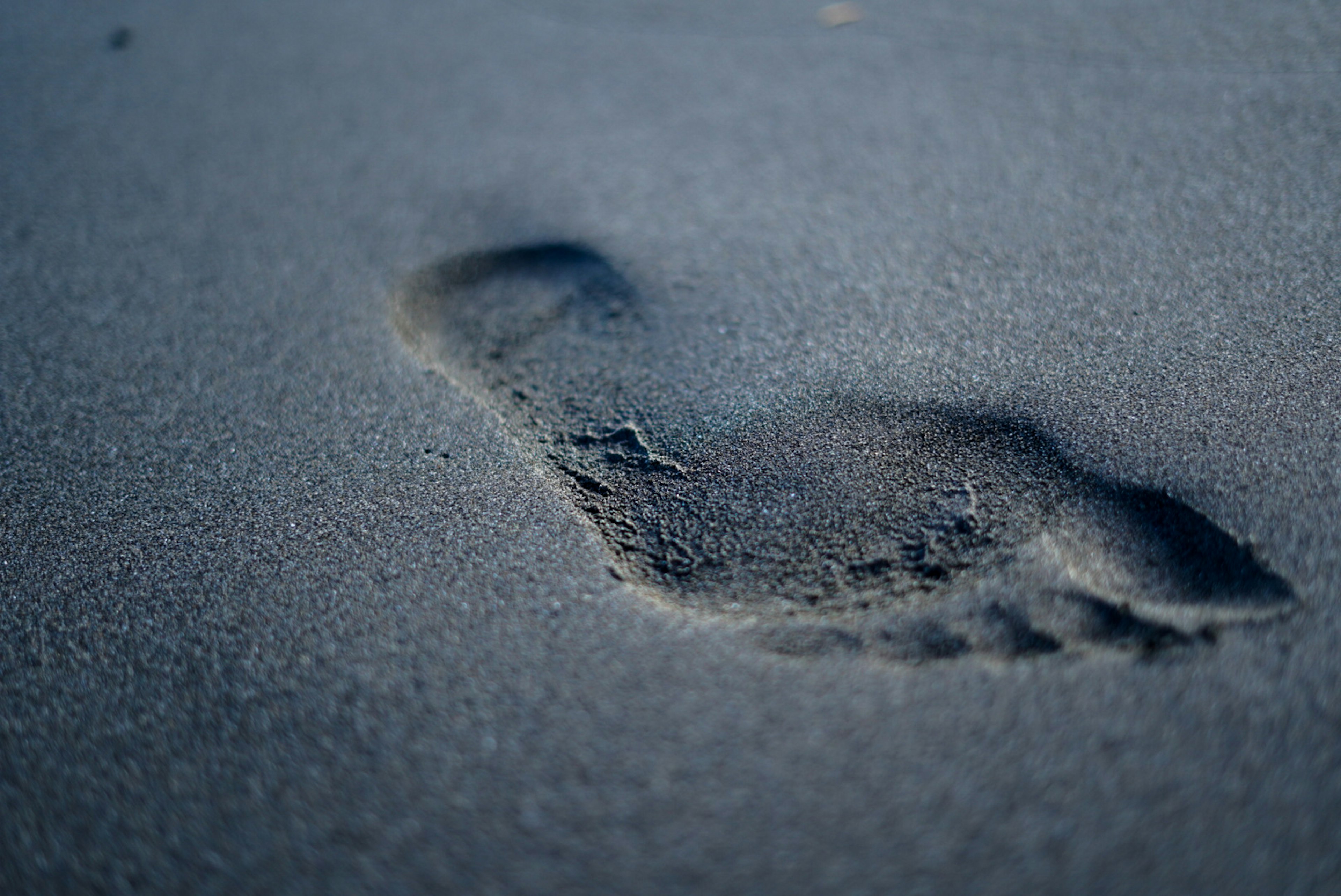 Close-up of a human footprint on the sand