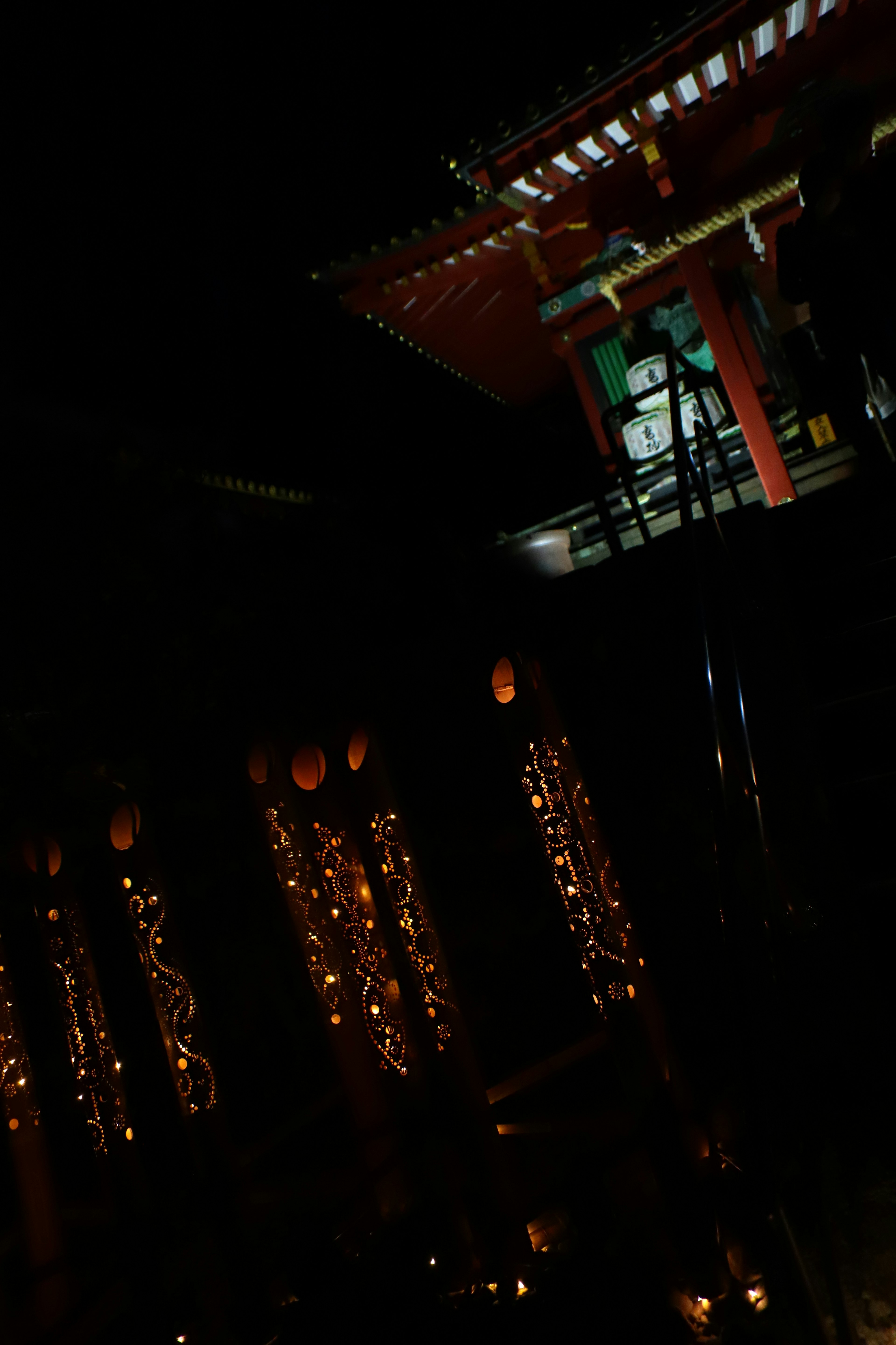 Beautiful nighttime scene of a shrine featuring a red building and decorative lighting