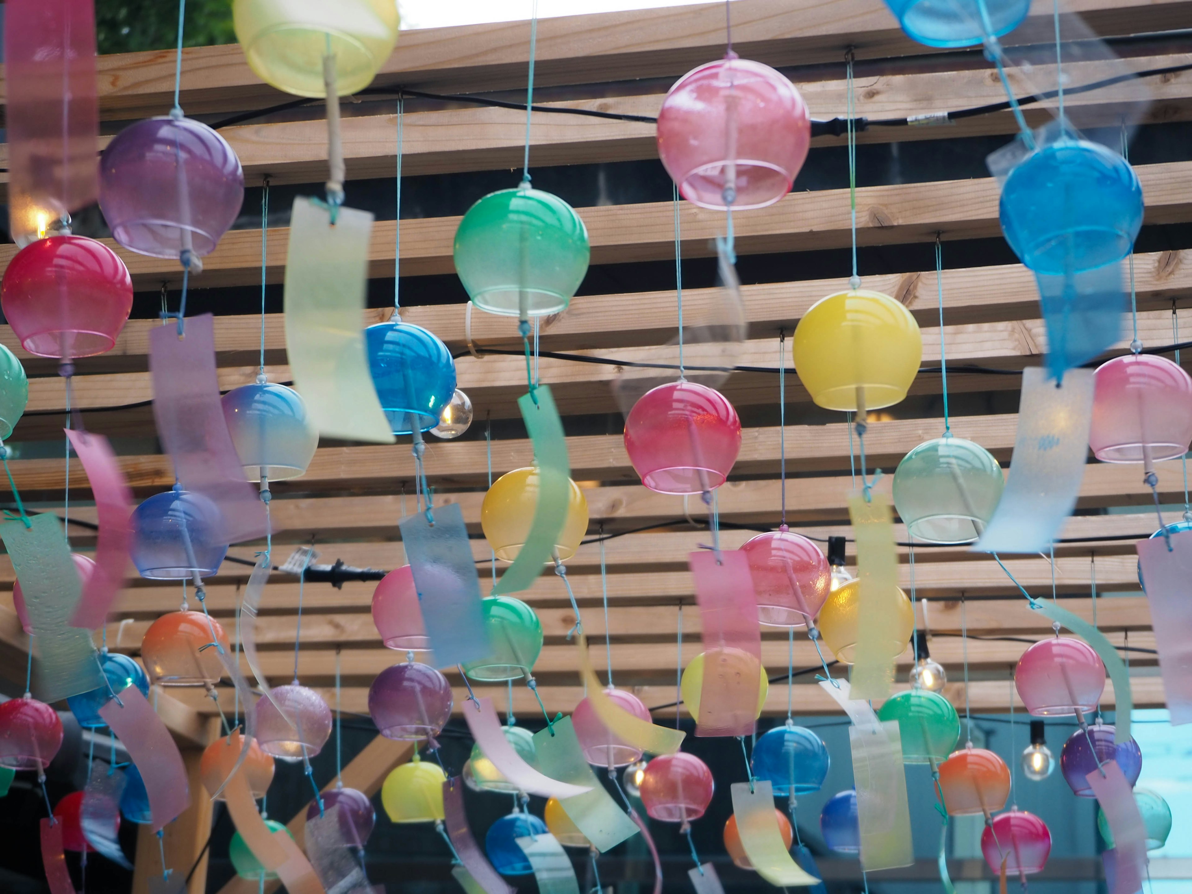 Colorful lanterns and ribbons hanging in a decorative space