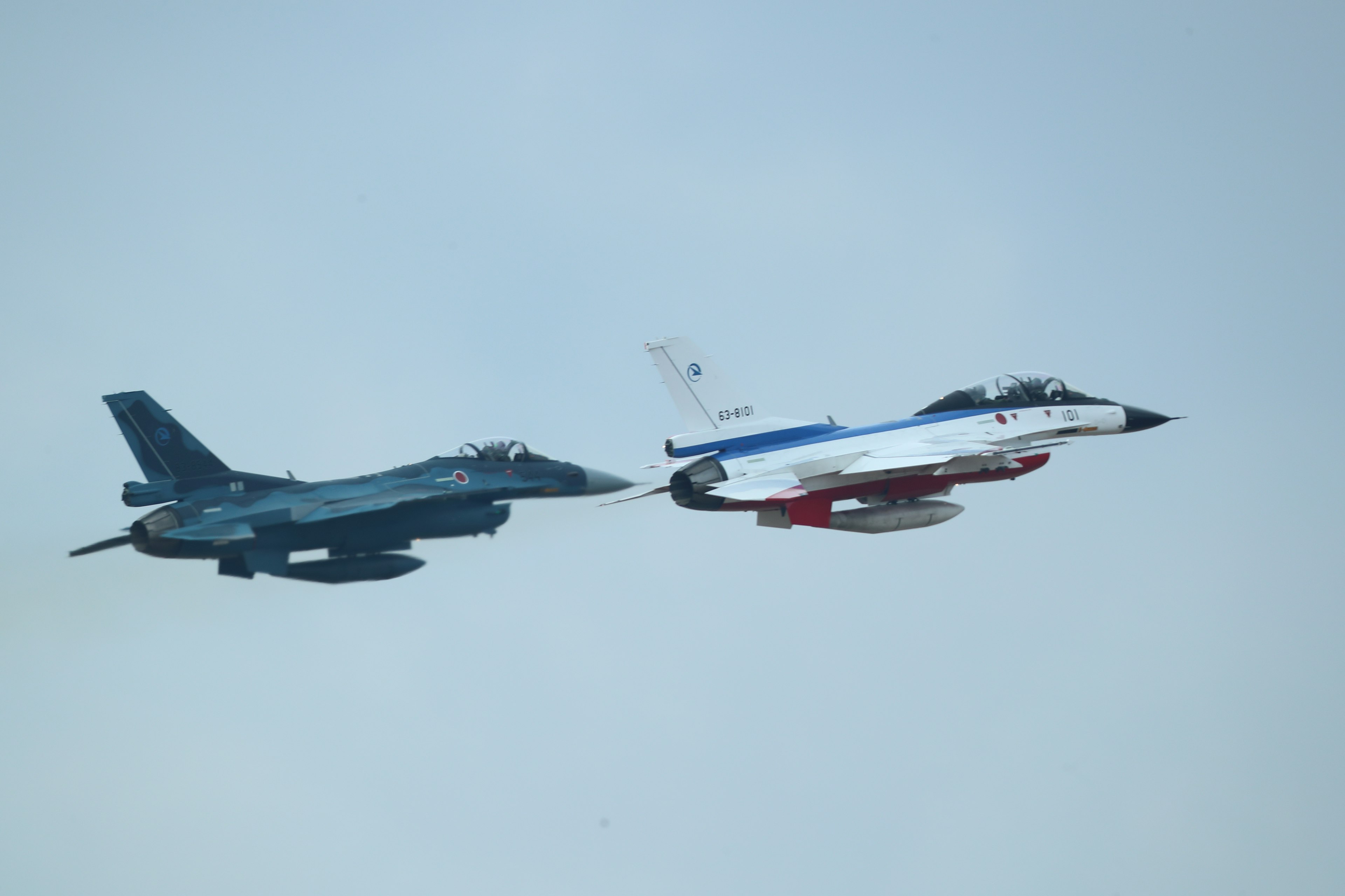 Two fighter jets flying in formation in the sky