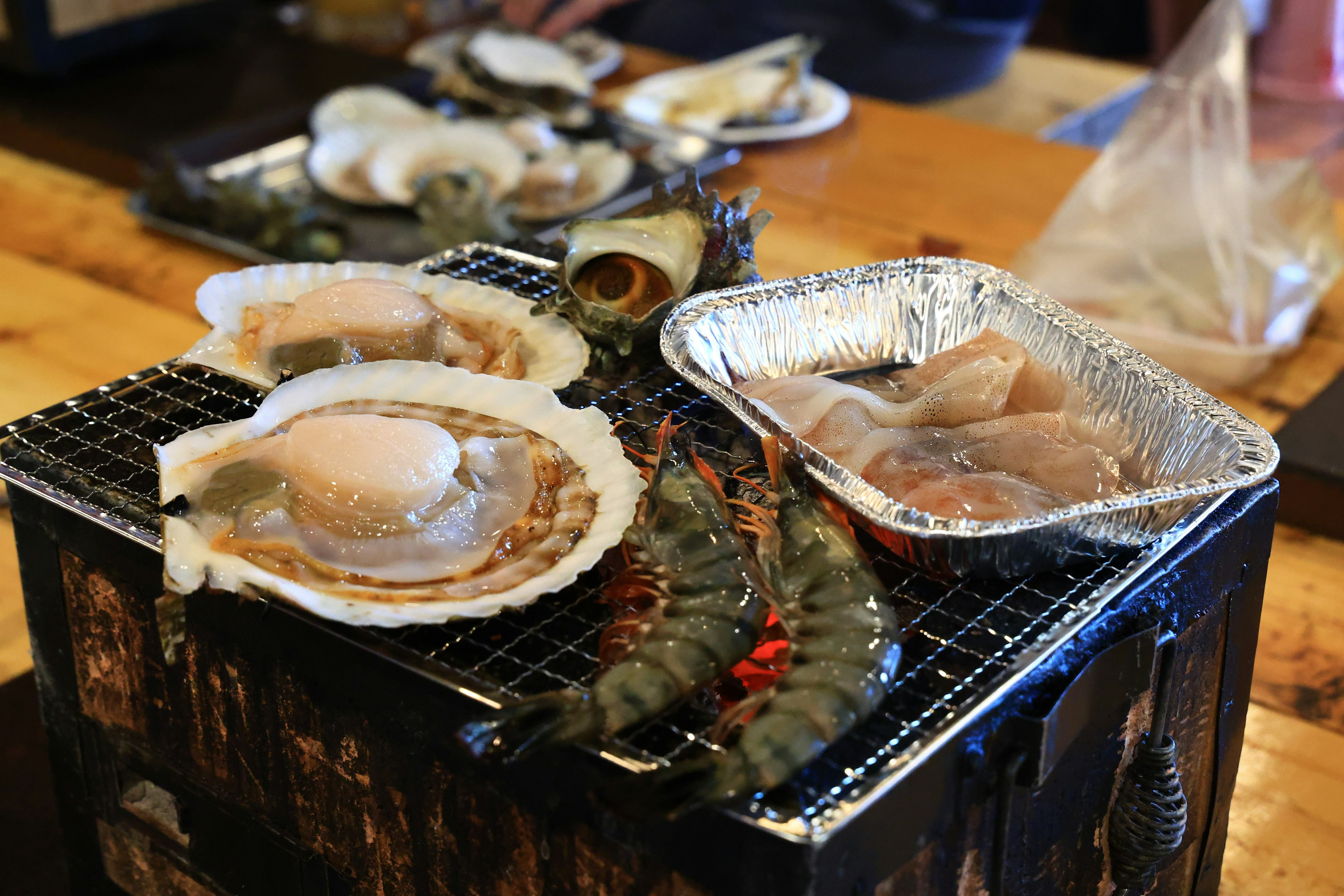 Grilled scallops and shrimp on a charcoal grill