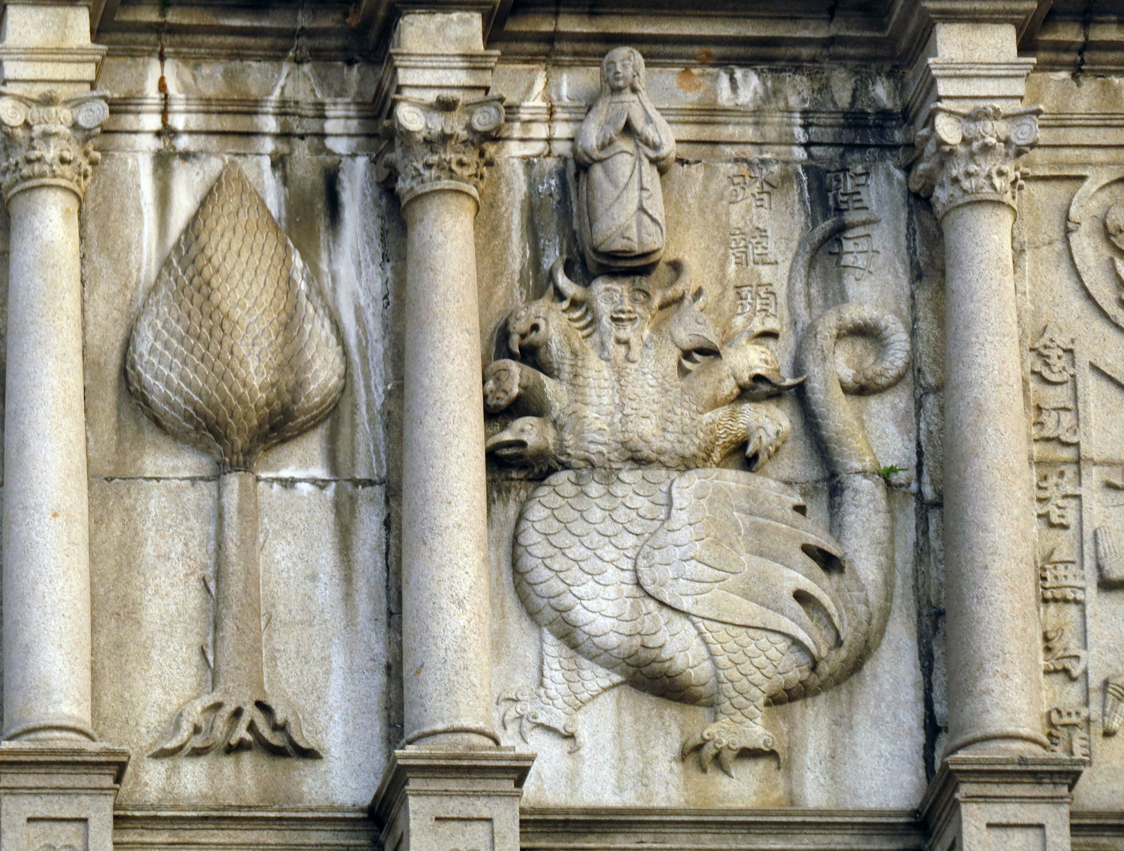 Wall sculpture featuring a plant and dragon design