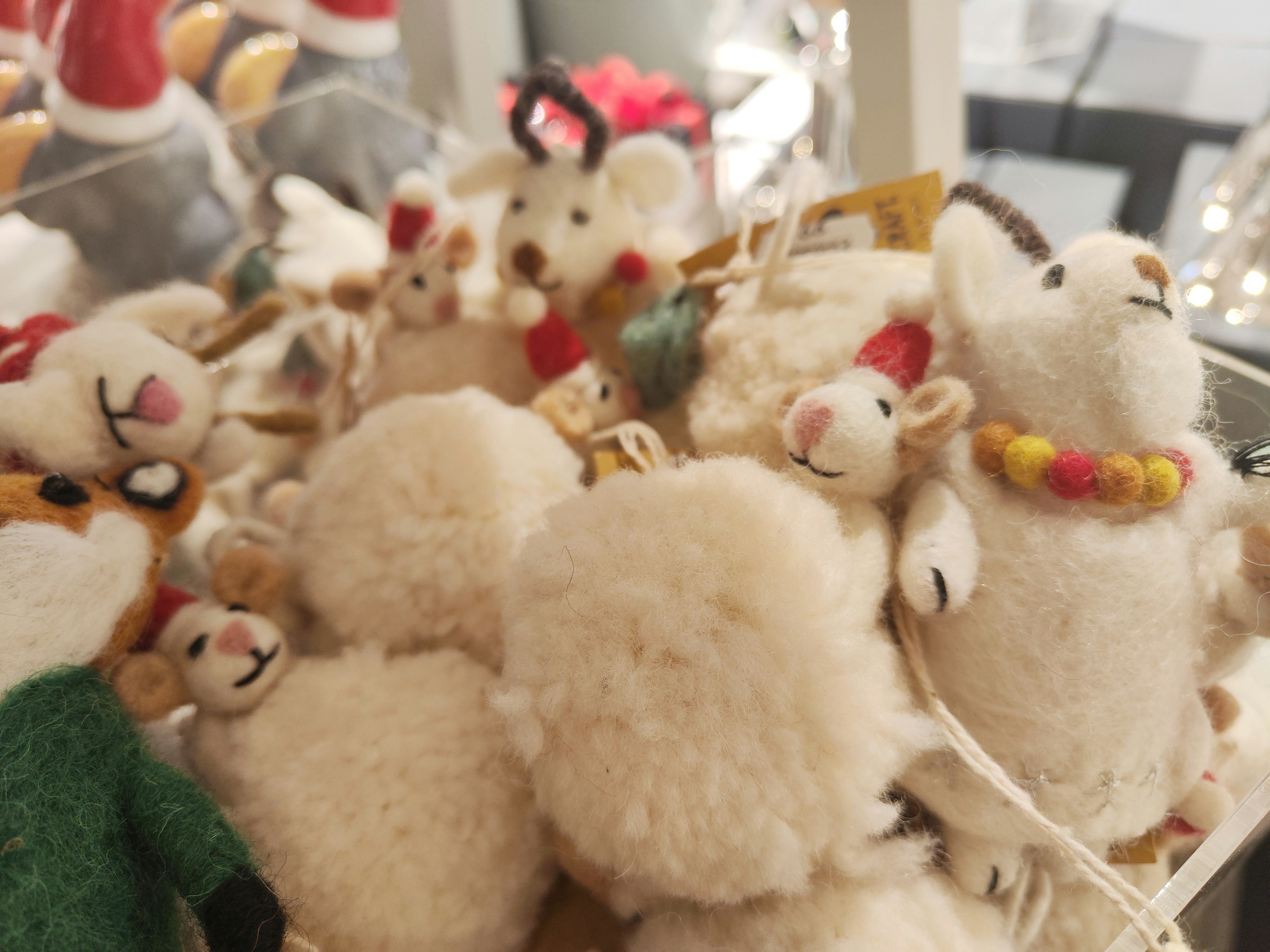 A collection of cute sheep figurines made of soft wool with various colors and designs