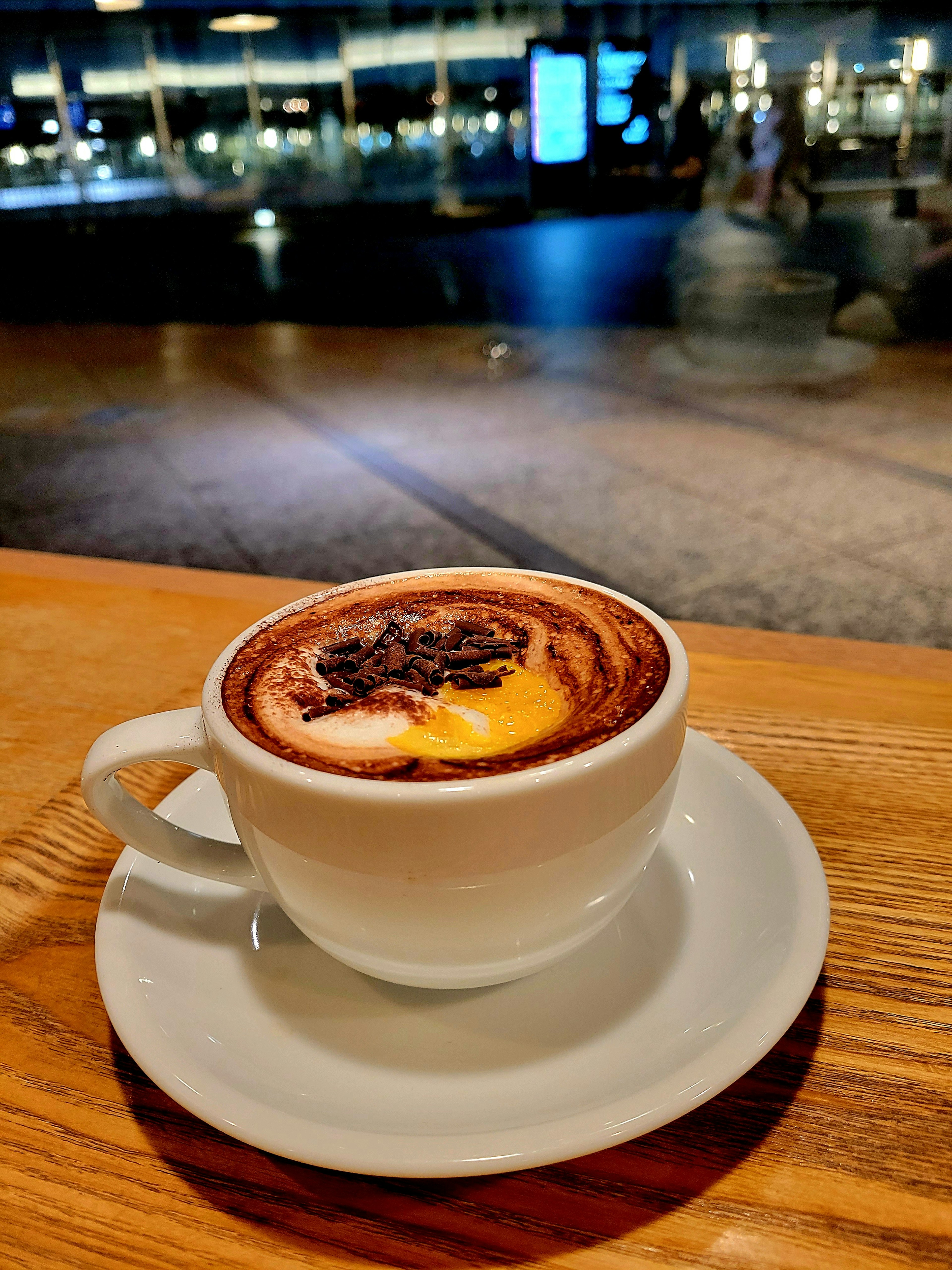 A creamy latte art cup placed on a café table