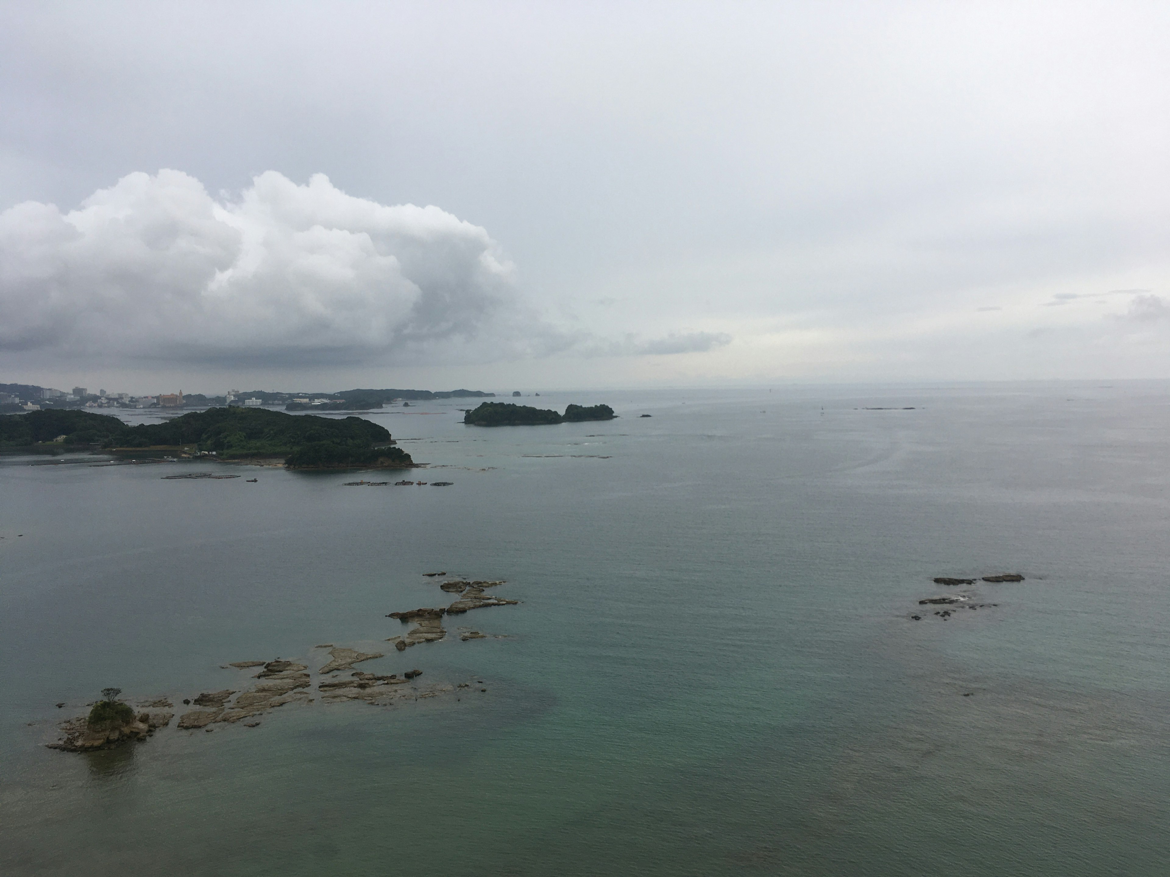 Calm sea under cloudy sky with small islands