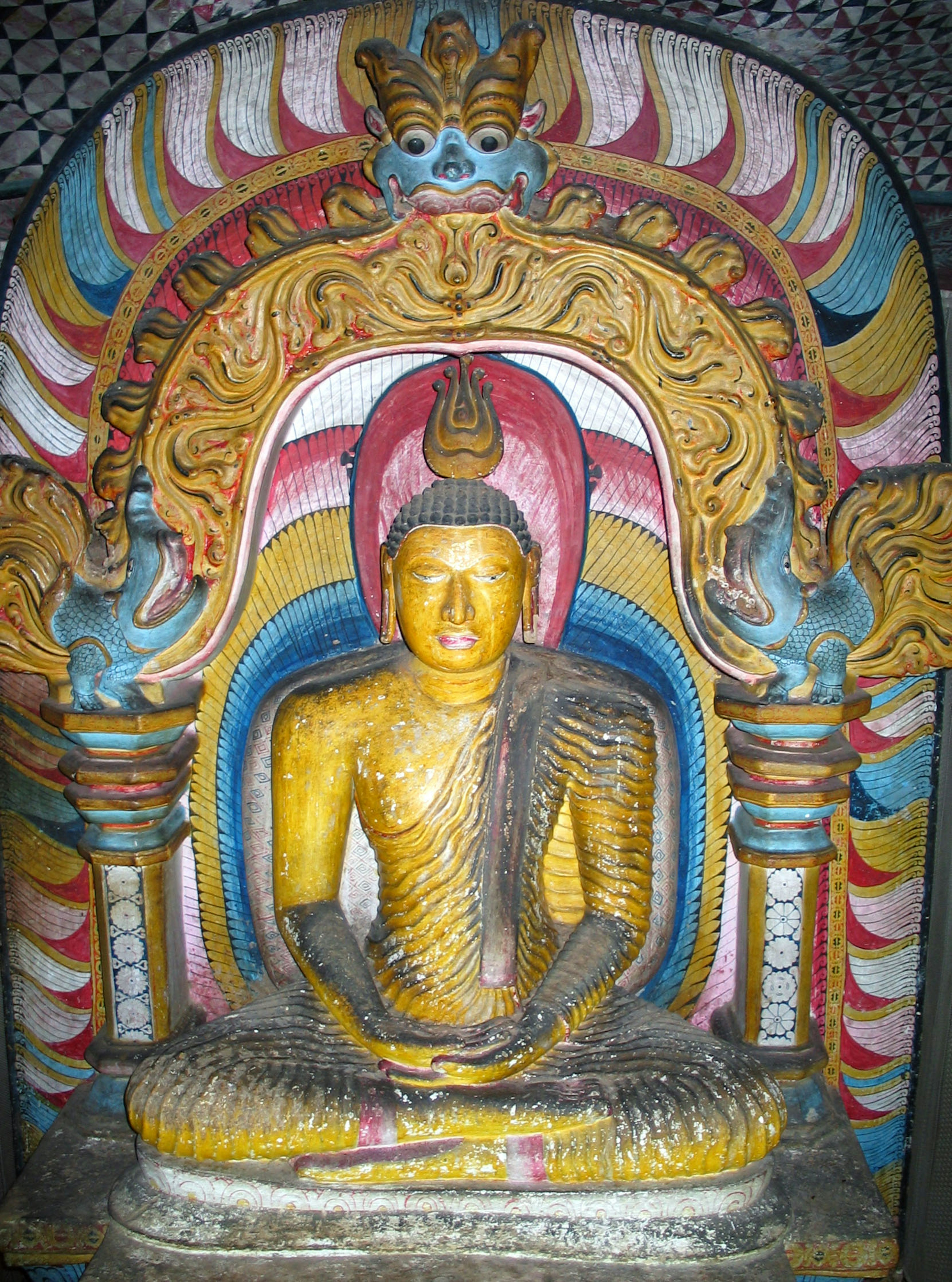 Vibrant Buddha statue seated in a temple alcove