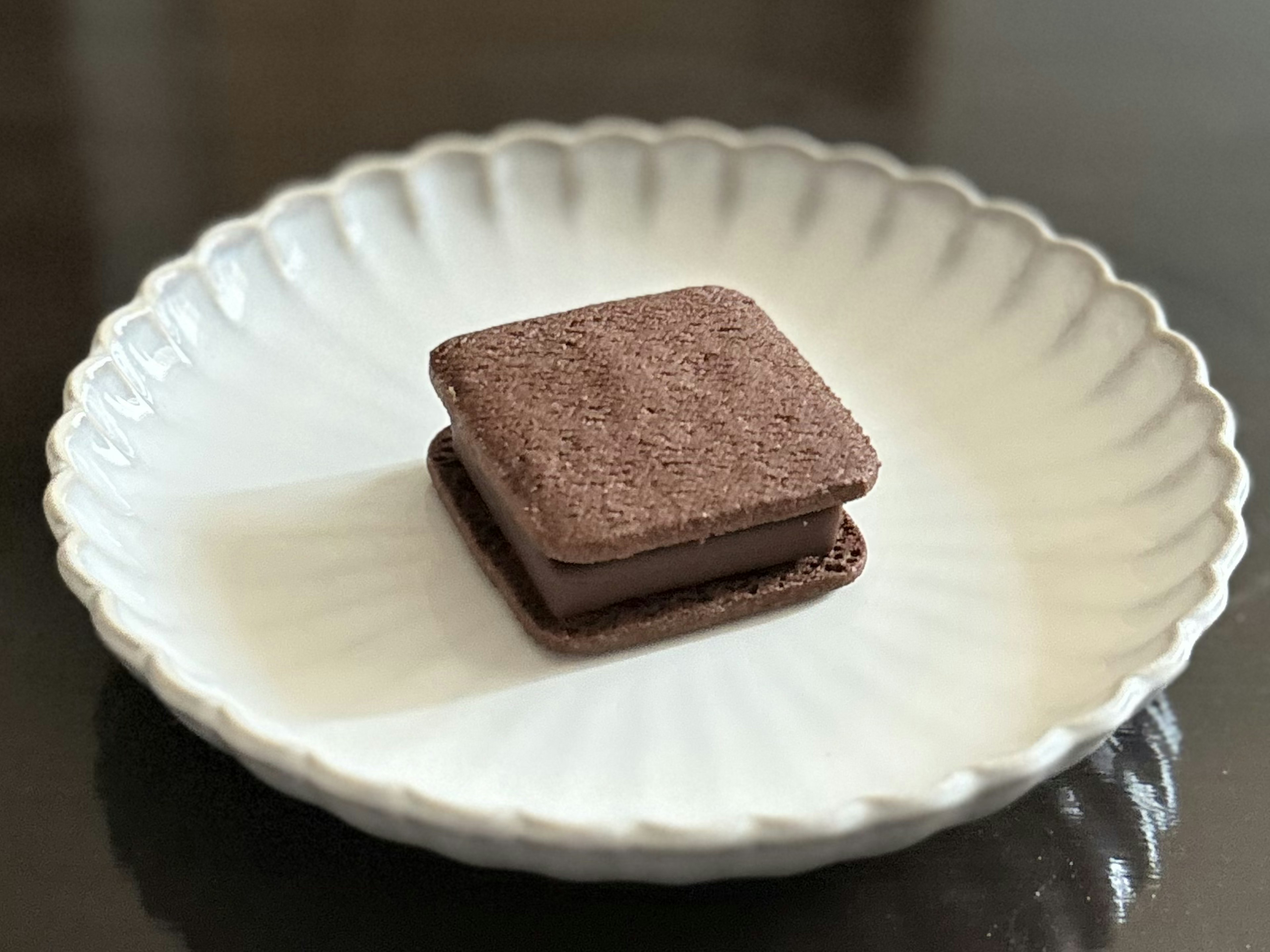 Chocolate sandwich cookie on a white plate