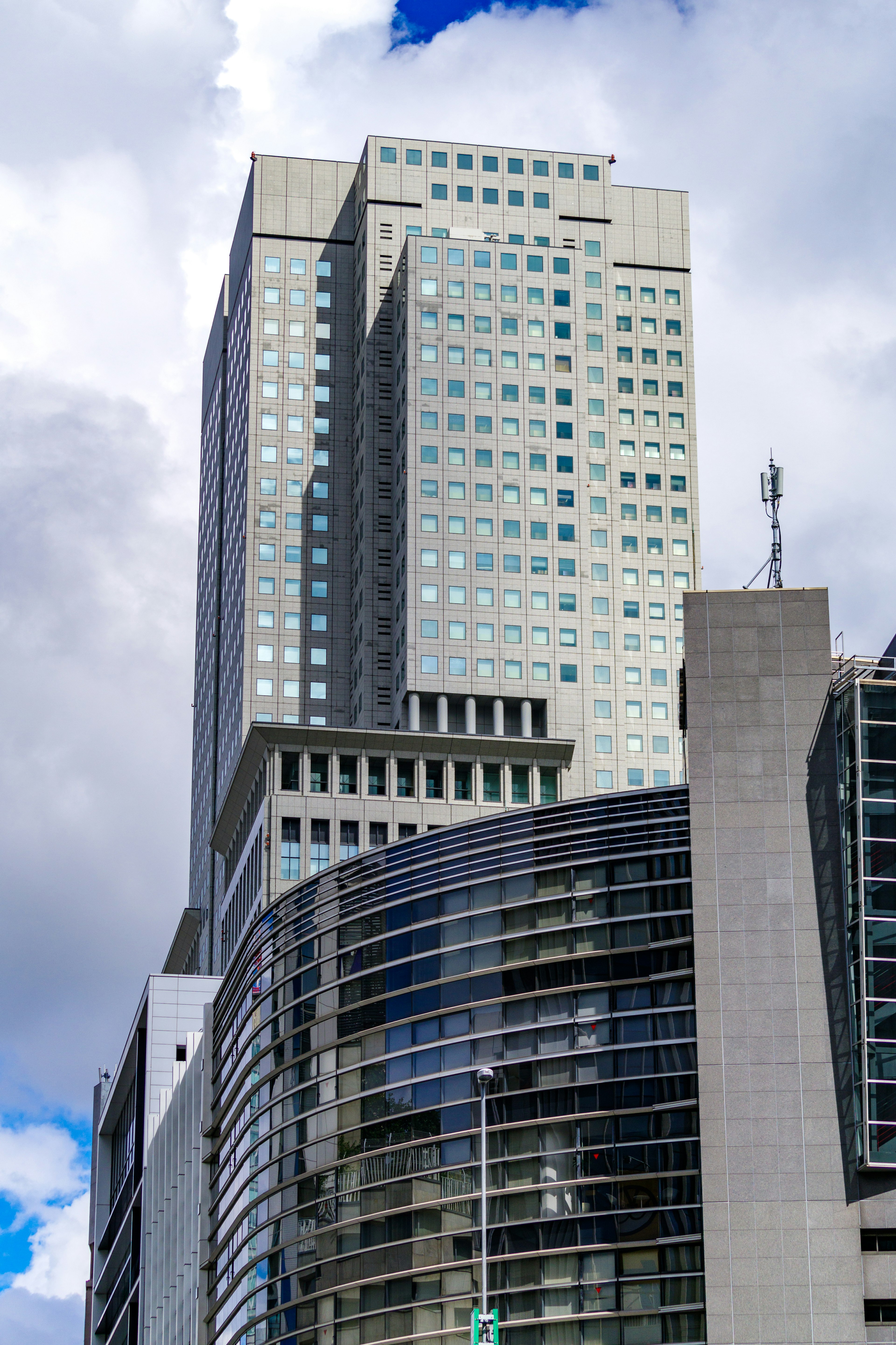 Urban landscape featuring a tall skyscraper and modern architectural design