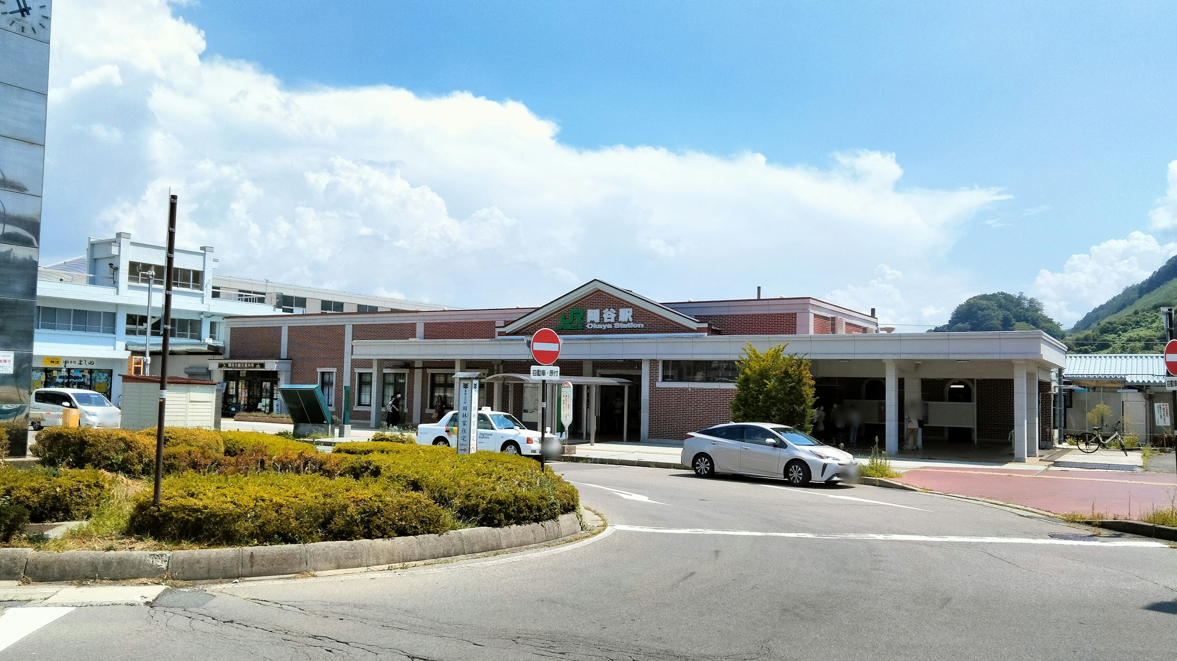 A train station building with surrounding landscape