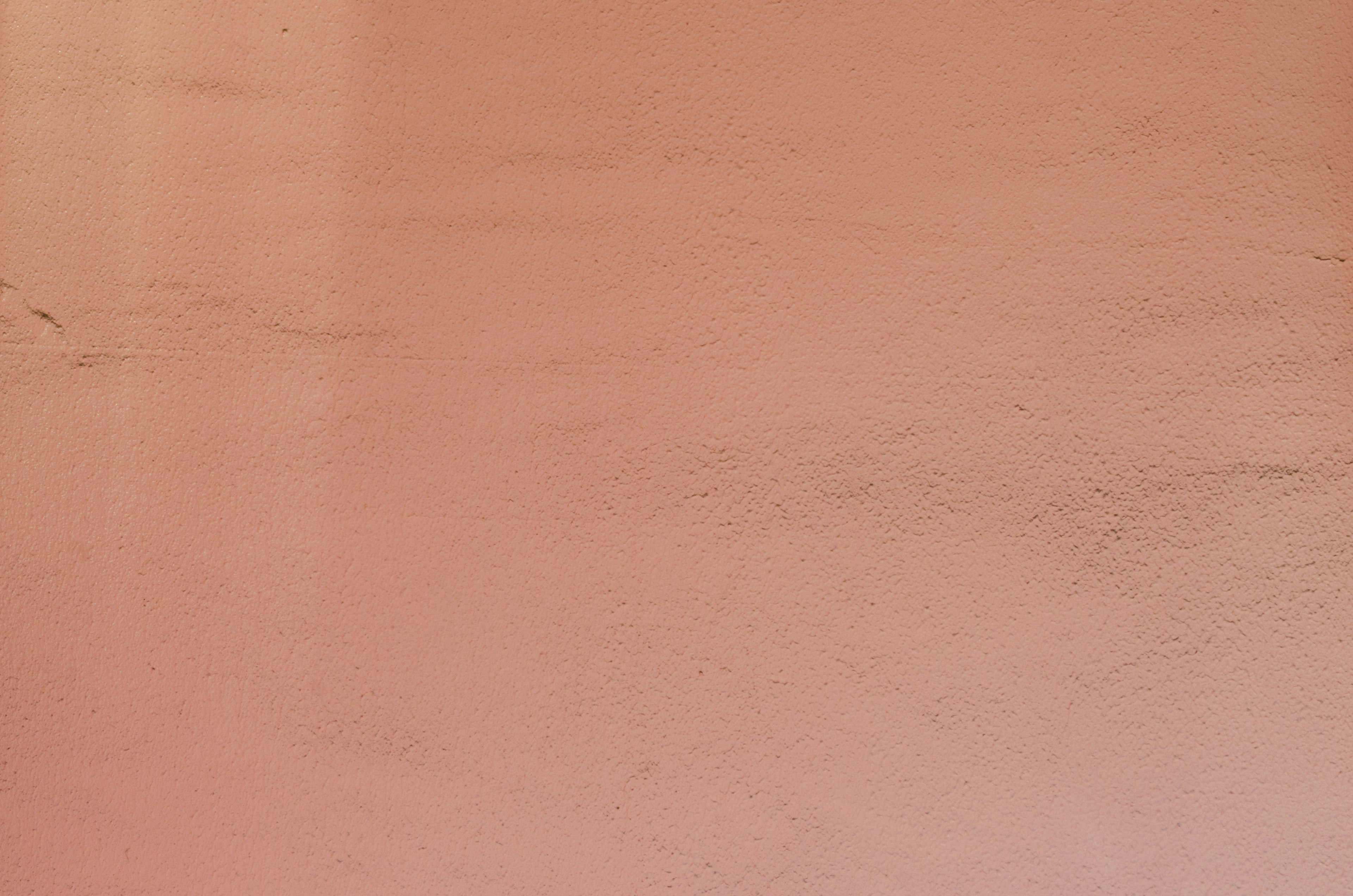 Textured surface of a light orange wall