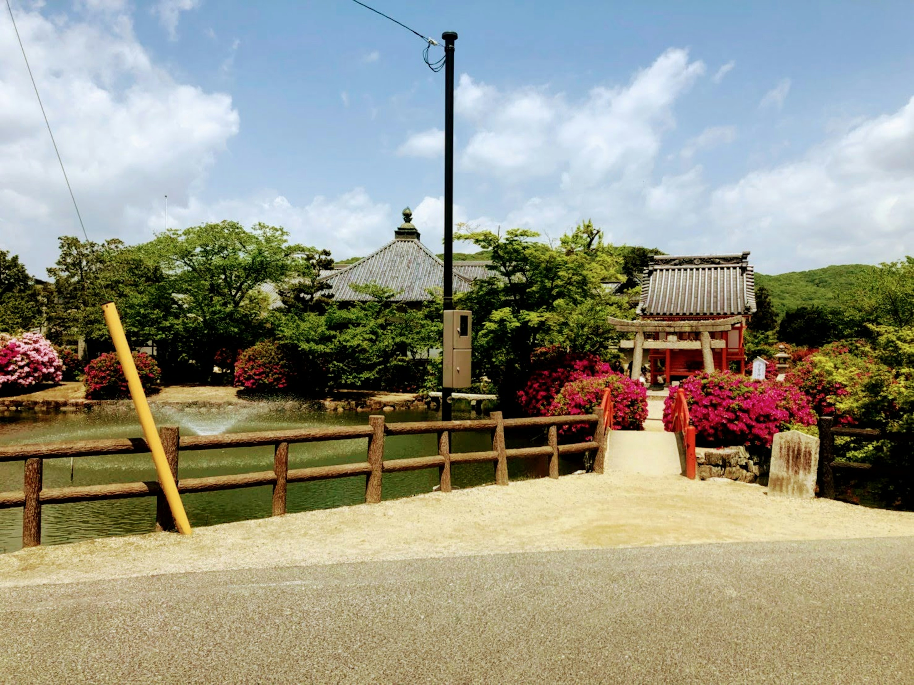 Scenic view of a traditional Japanese garden with vibrant flowers and a historic building