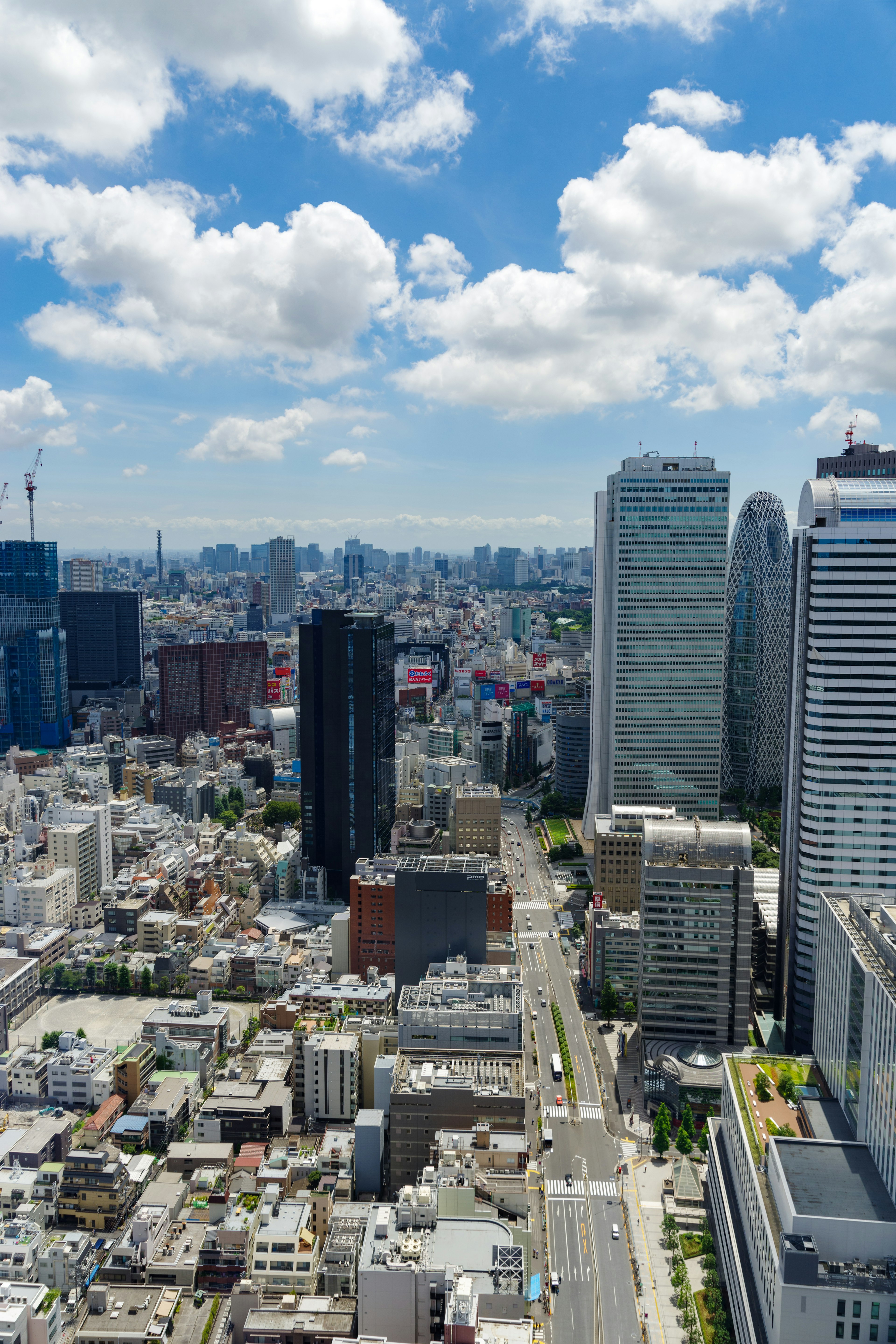 Tokyo cityscape with skyscrapers and blue sky featuring white clouds