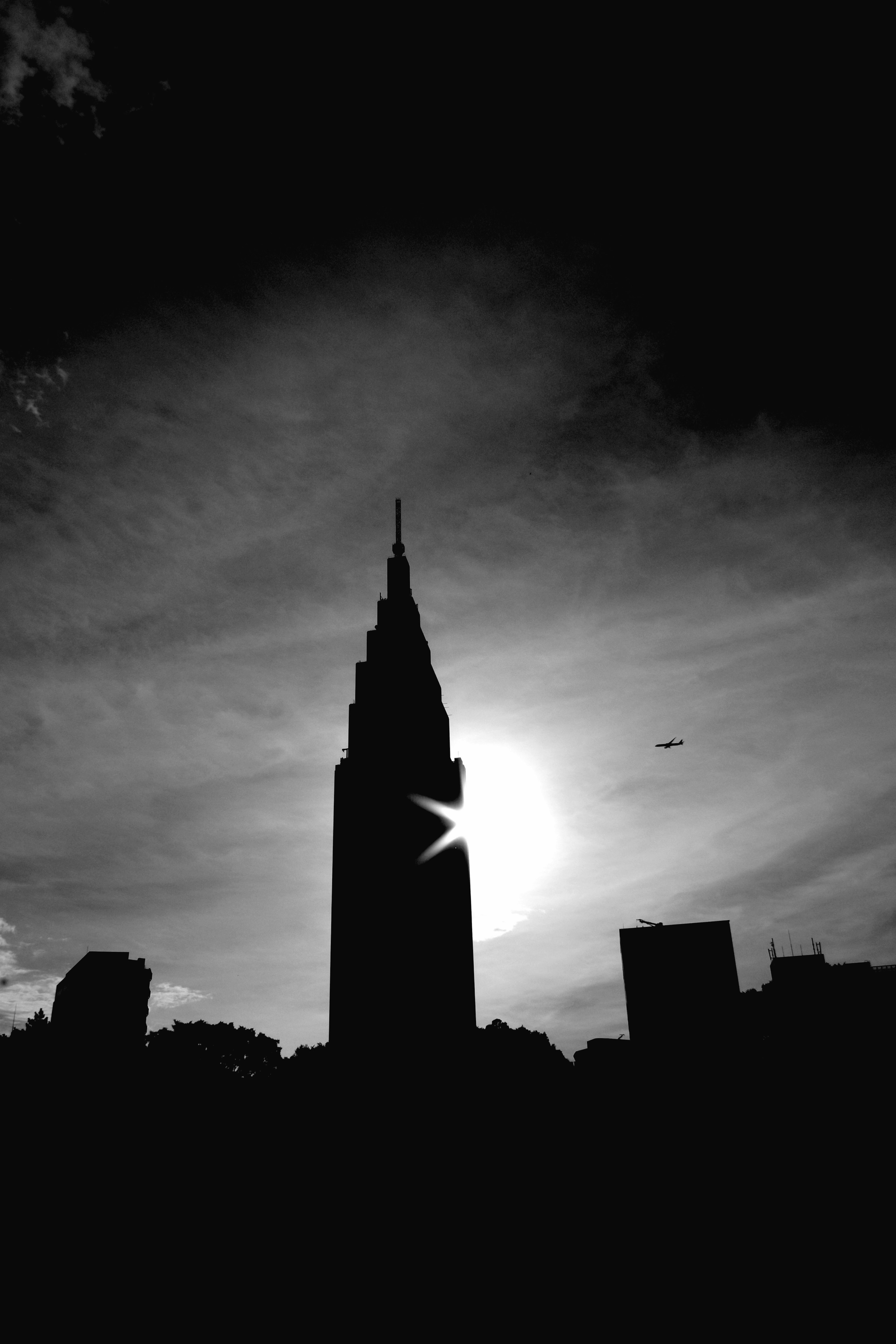 Siluet Empire State Building dengan matahari terbenam di latar belakang