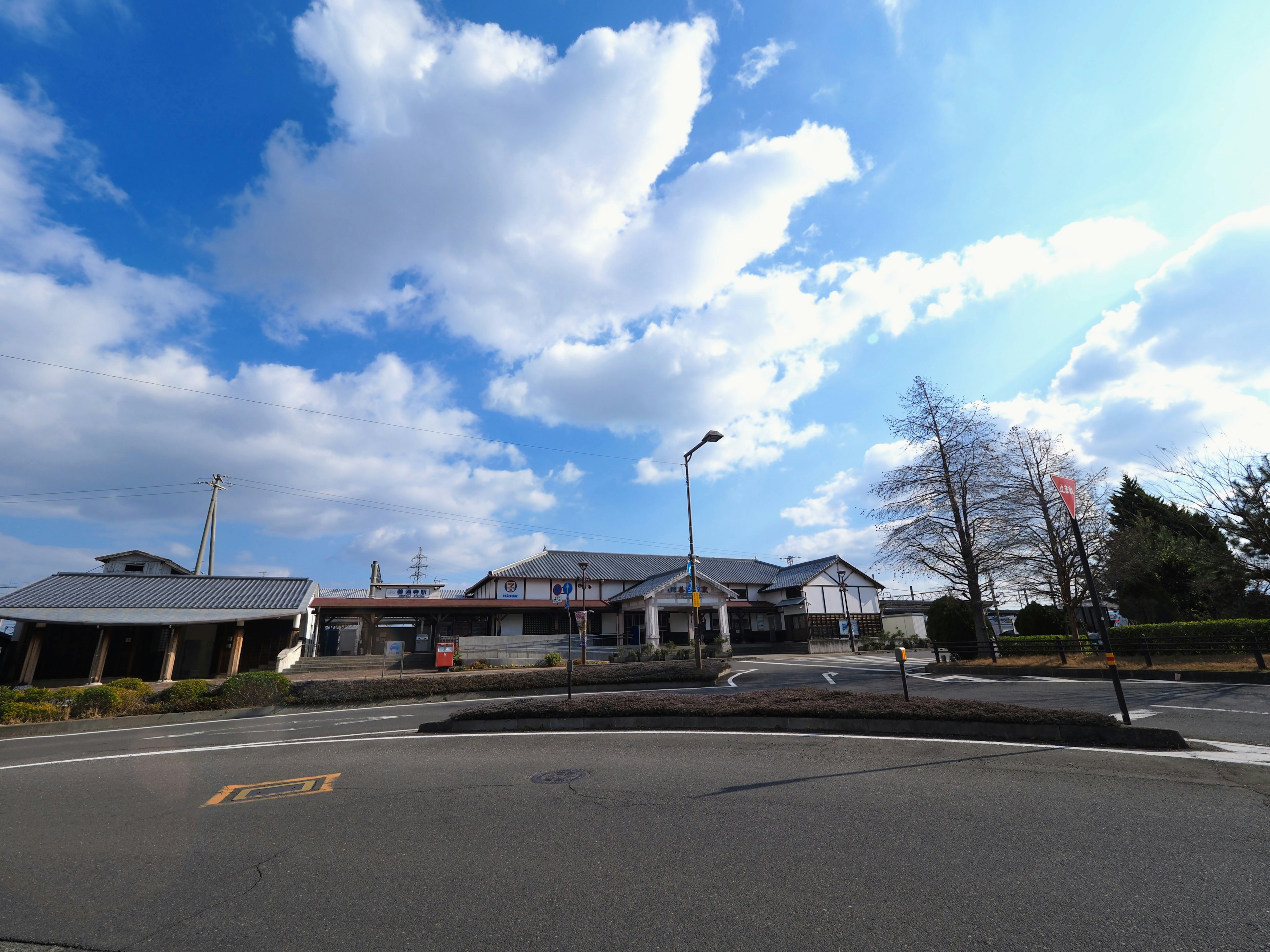 Landscape with buildings under a blue sky and white clouds