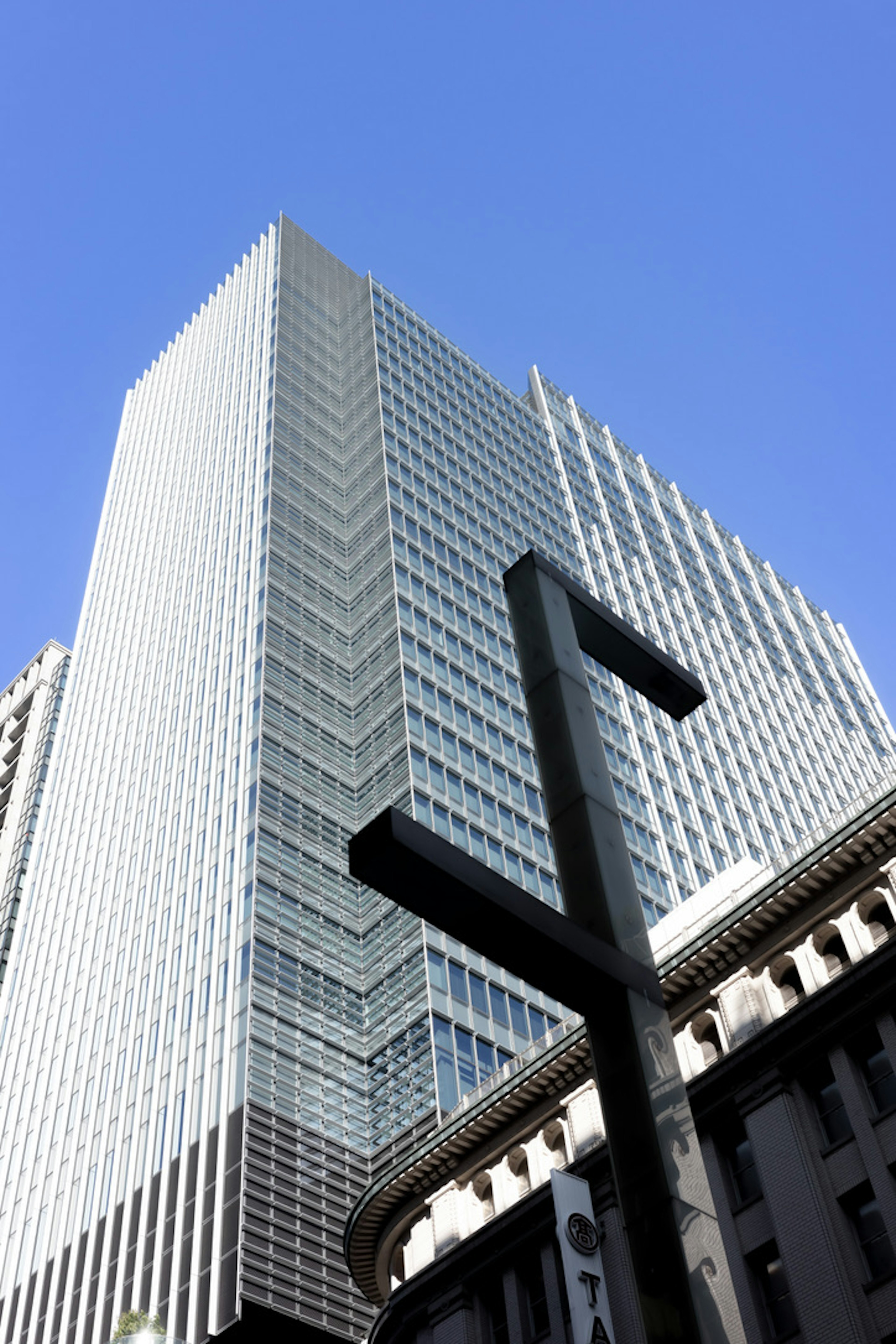 高層ビルと青空のコントラストを示す都市景観