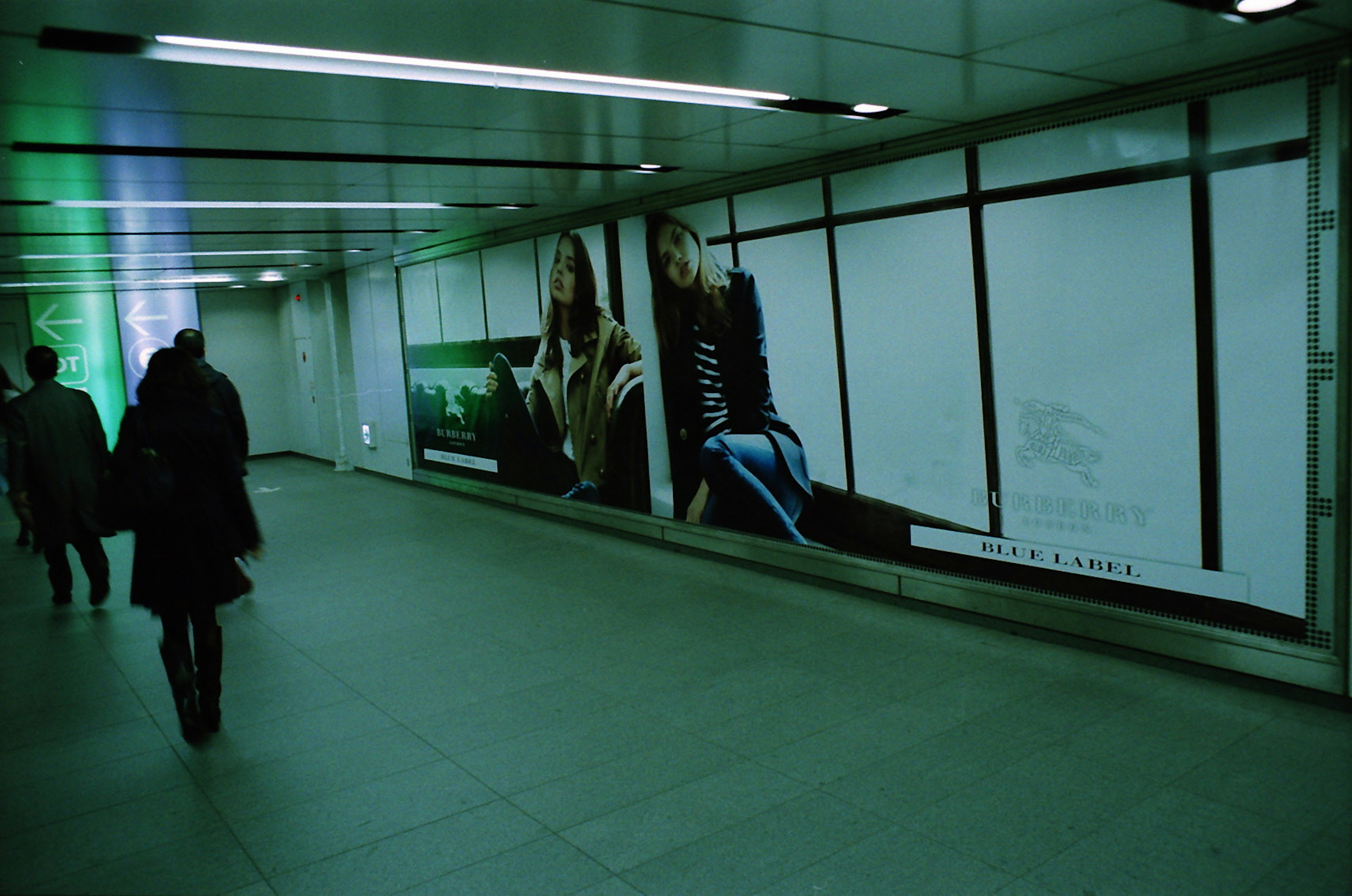 Advertising wall in a subway with pedestrians