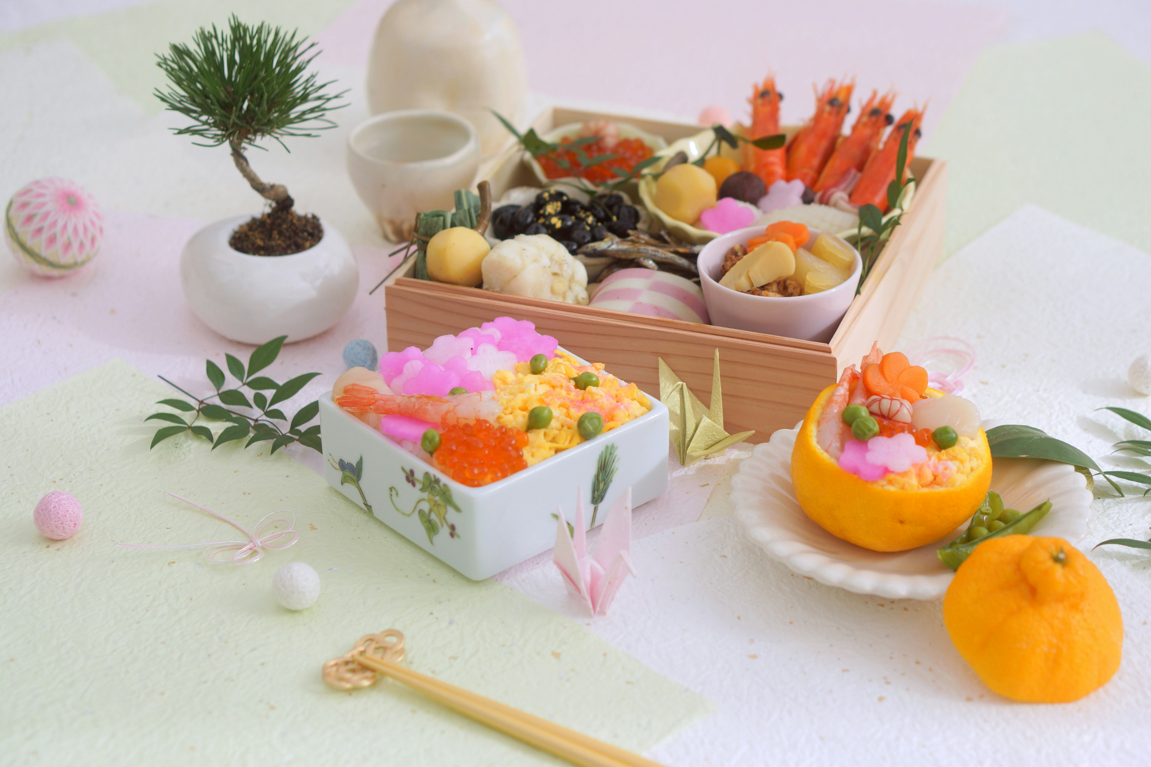 Beautifully arranged traditional Japanese cuisine in a bento box with fruits