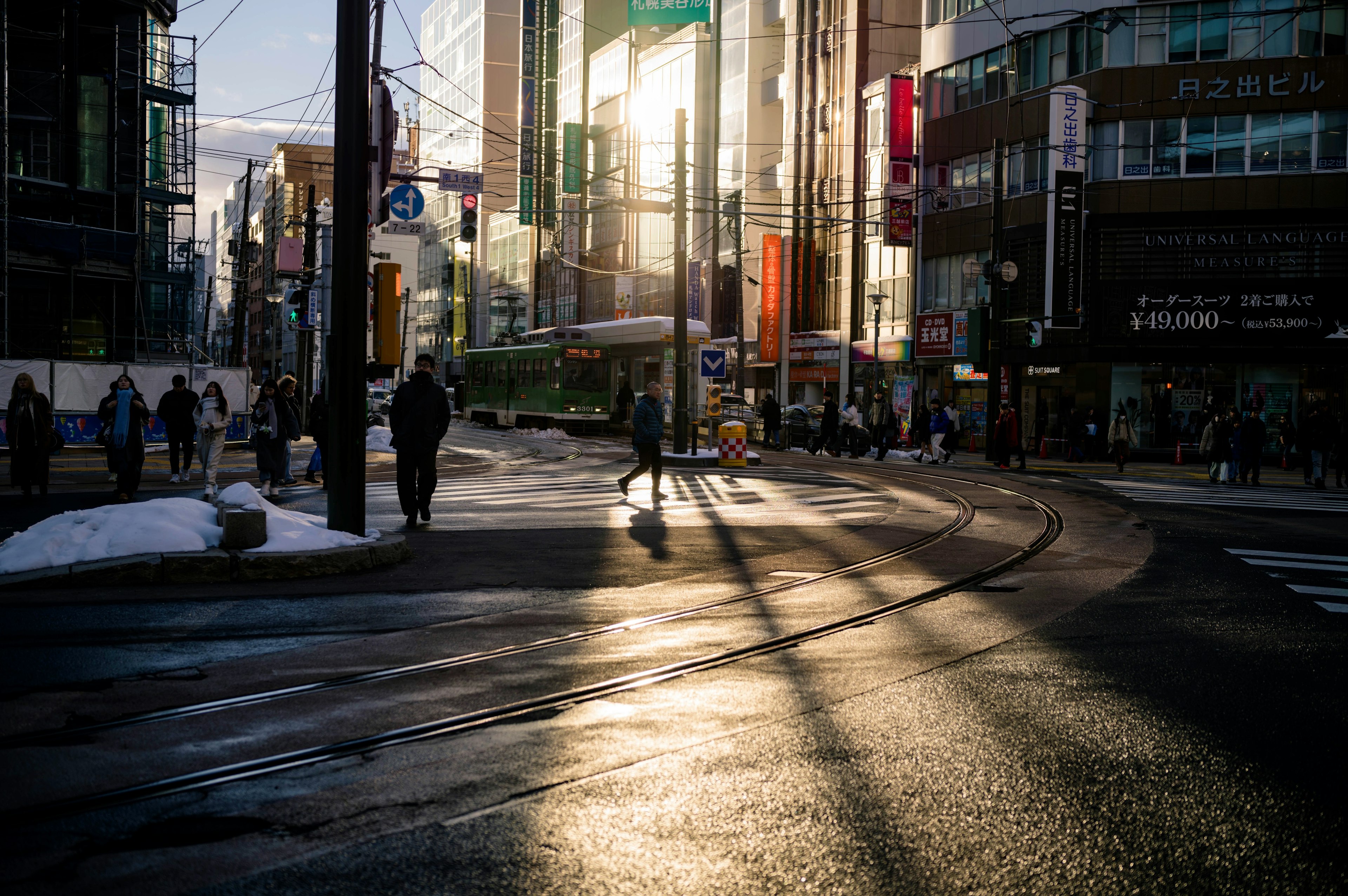 黃昏時分的城市景象，有行人穿越街道