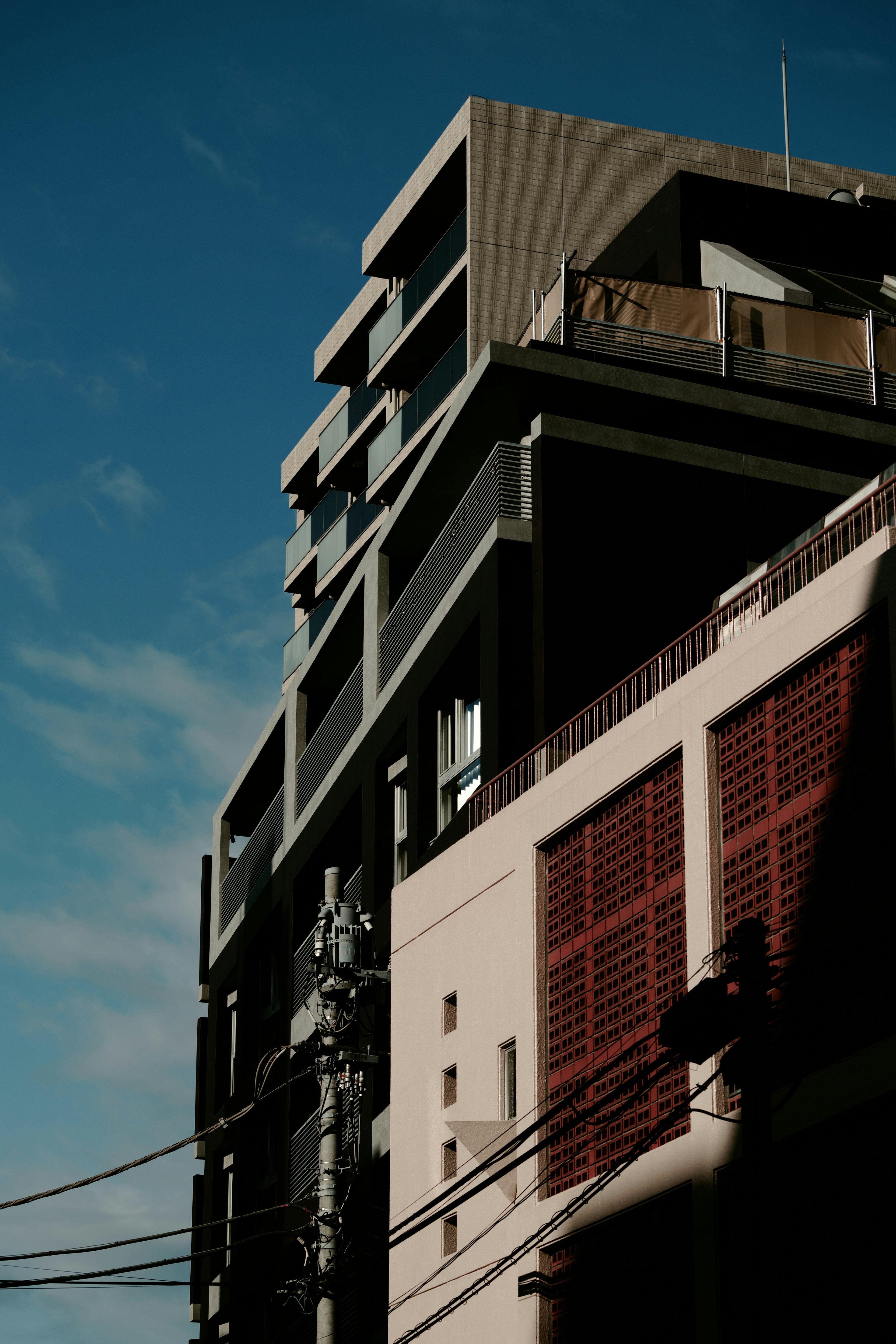 Urban landscape featuring a high-rise building against a blue sky